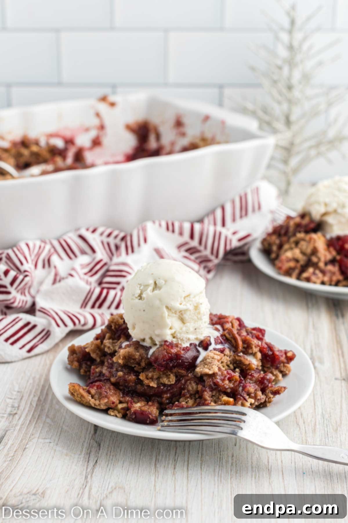 Christmas dump cake served with vanilla ice cream, showcasing its warm, inviting appeal and festive colors.