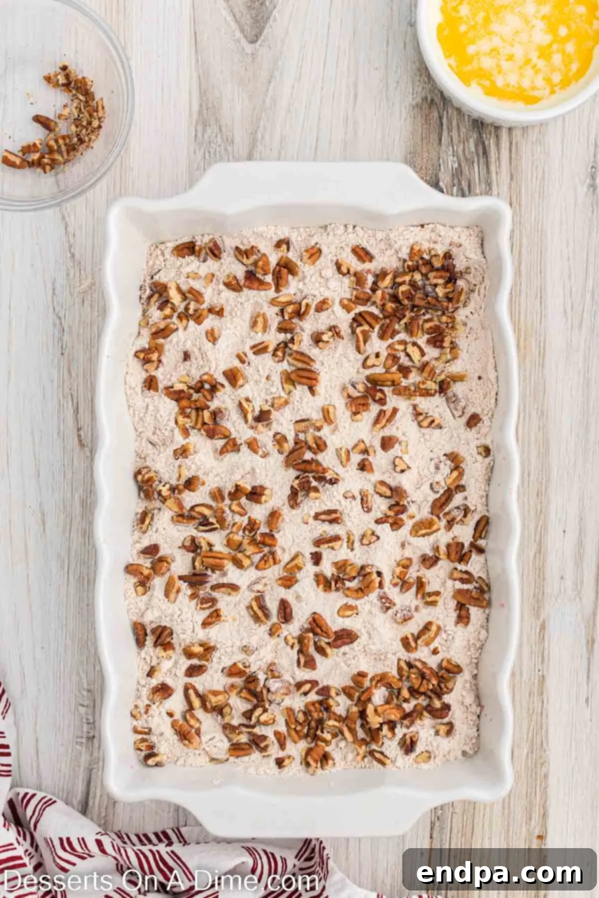 Chopped pecans sprinkled generously over the dry cake mix layer.