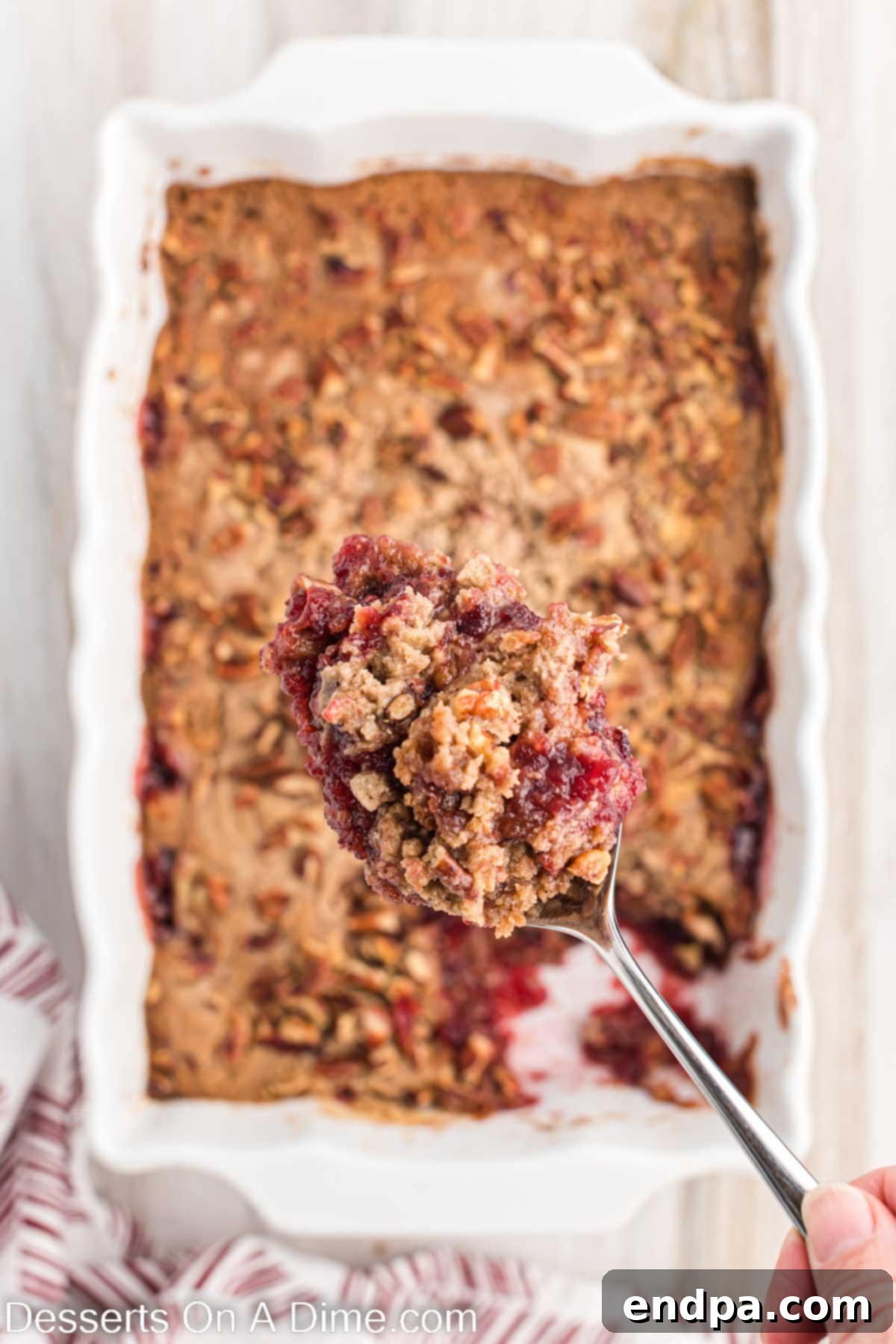 The full Christmas dump cake in a baking dish, showcasing its golden-brown top and festive cranberry filling.