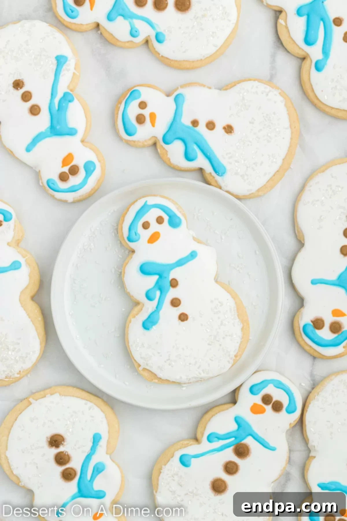 Collection of festive Starbucks-inspired snowman cookies with colorful icing decorations.