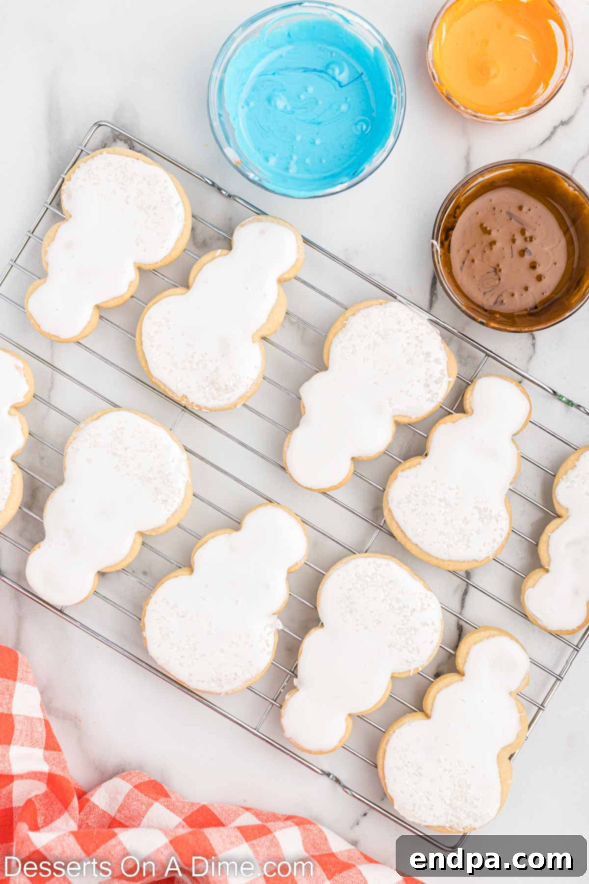 A cookie covered in white royal icing, ready for further decoration.
