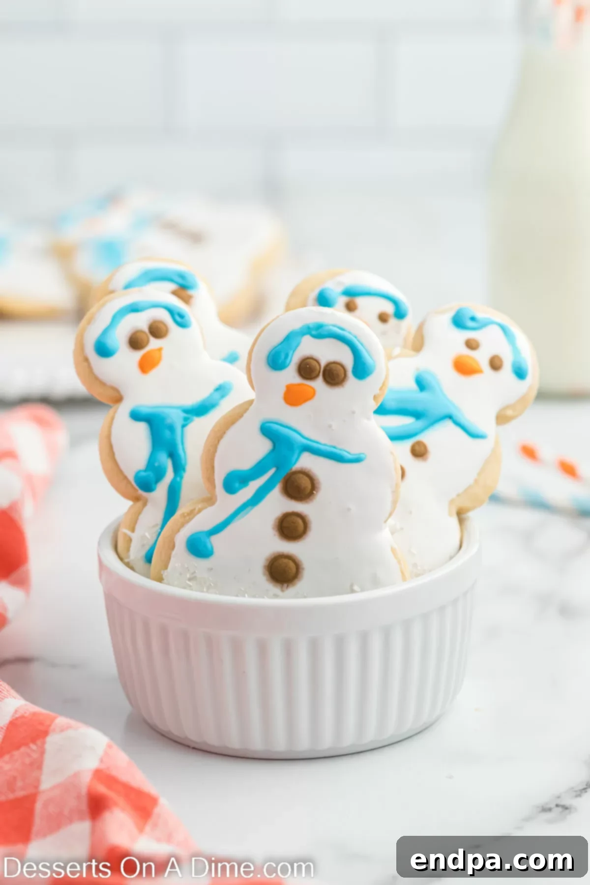 Assortment of freshly baked and decorated Starbucks snowman cookies arranged artfully.