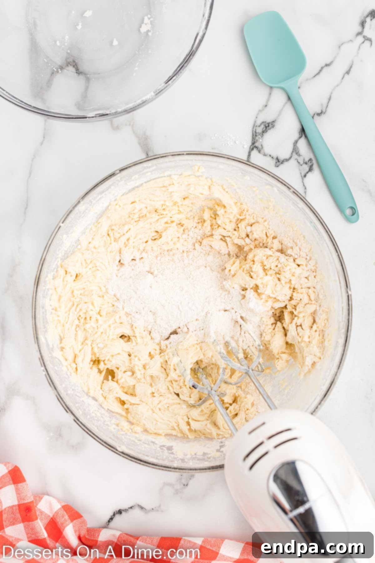 The dry flour mixture gradually being added to the wet butter and chocolate mixture.
