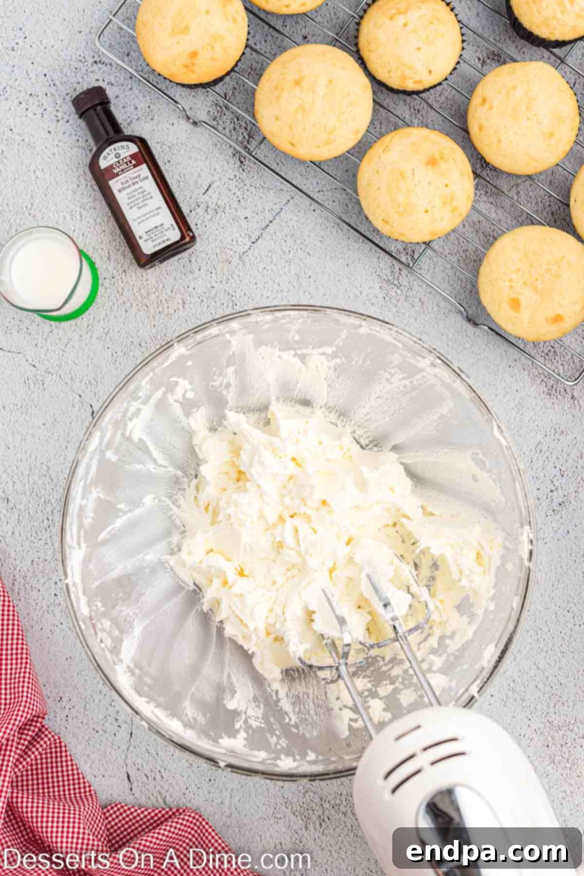 A bowl of creamy, white buttercream frosting ready for decorating.