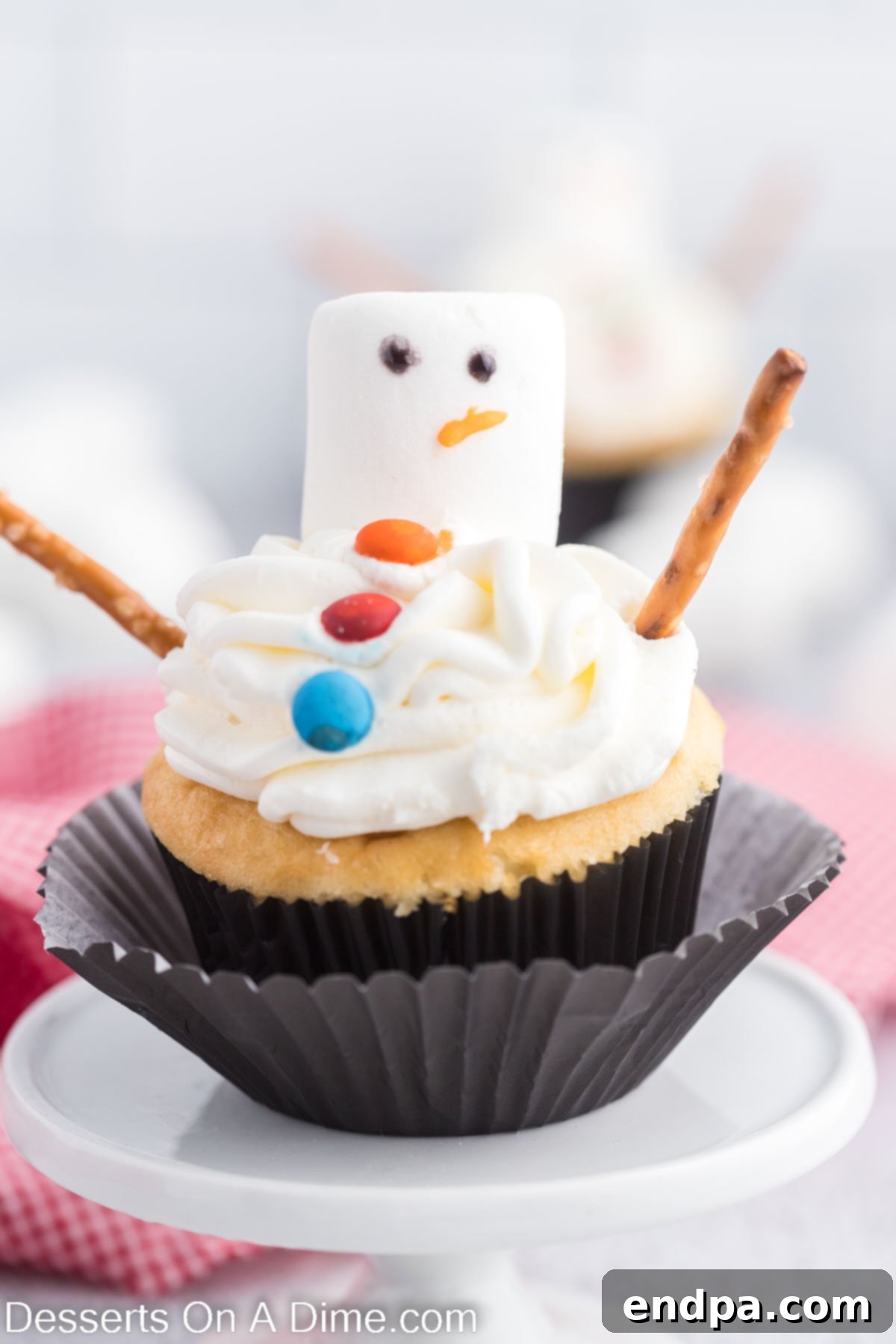 Fully decorated snowman cupcakes arranged on a platter, ready to be enjoyed.