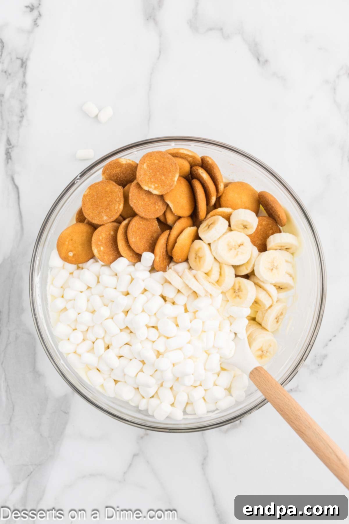Vanilla wafers, mini marshmallows and bananas combined into pudding mixture. 