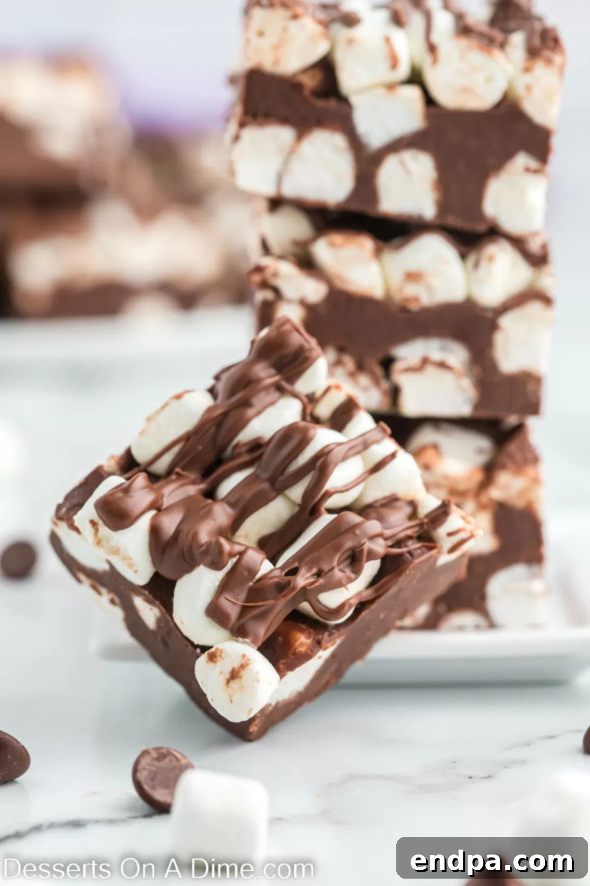 Hot chocolate fudge cut into squares, showcasing its rich texture and marshmallow topping.