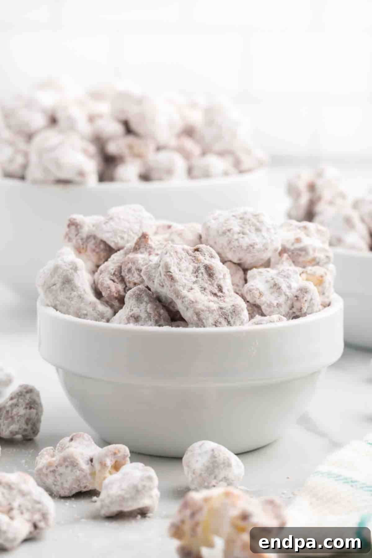 Muddy Buddy Popcorn Crunch 2 A bowl filled with delicious Puppy Chow Popcorn, ready to be enjoyed.
