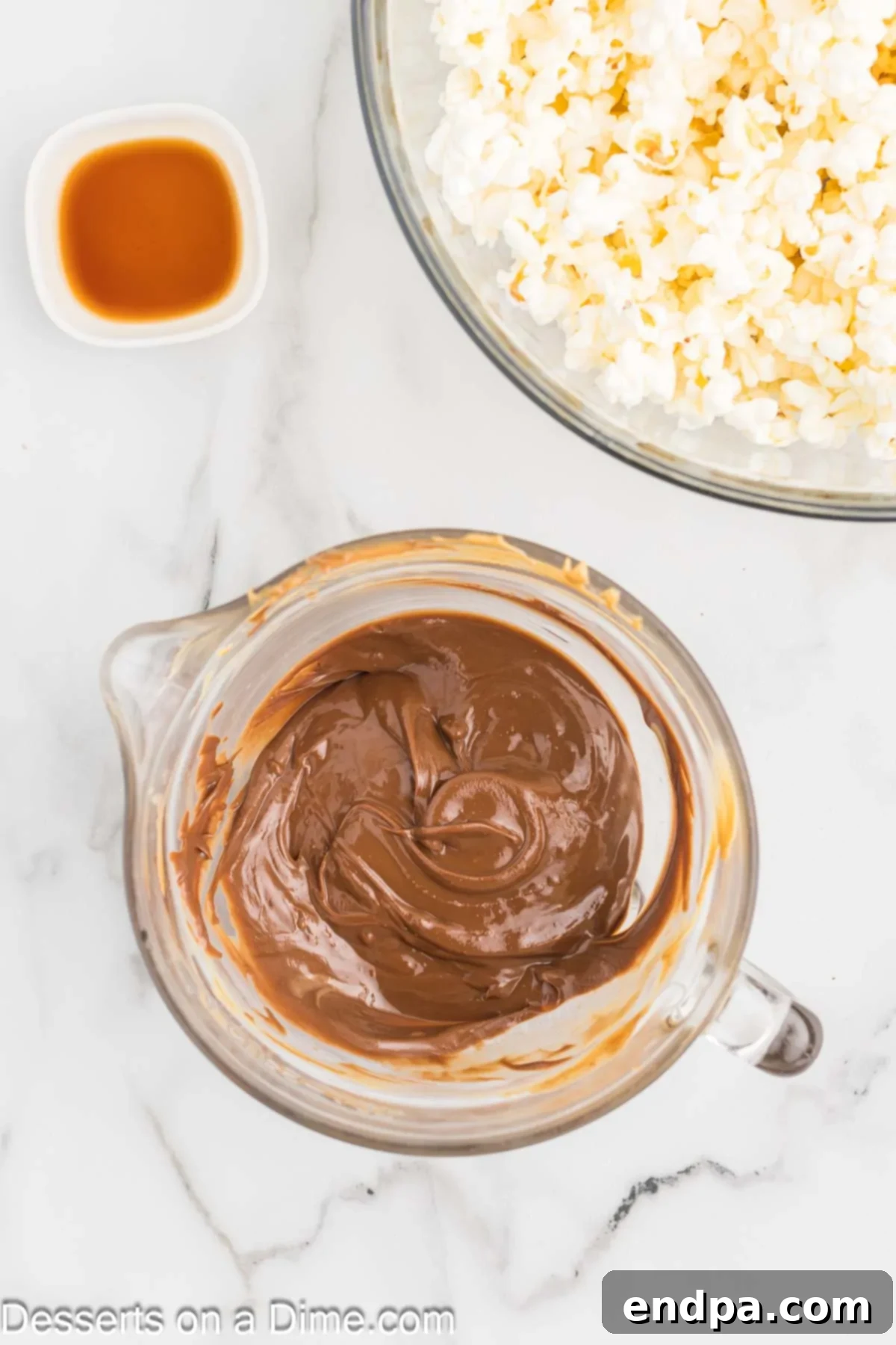 Muddy Buddy Popcorn Crunch 4 Melted chocolate and peanut butter mixture in a microwave-safe bowl.