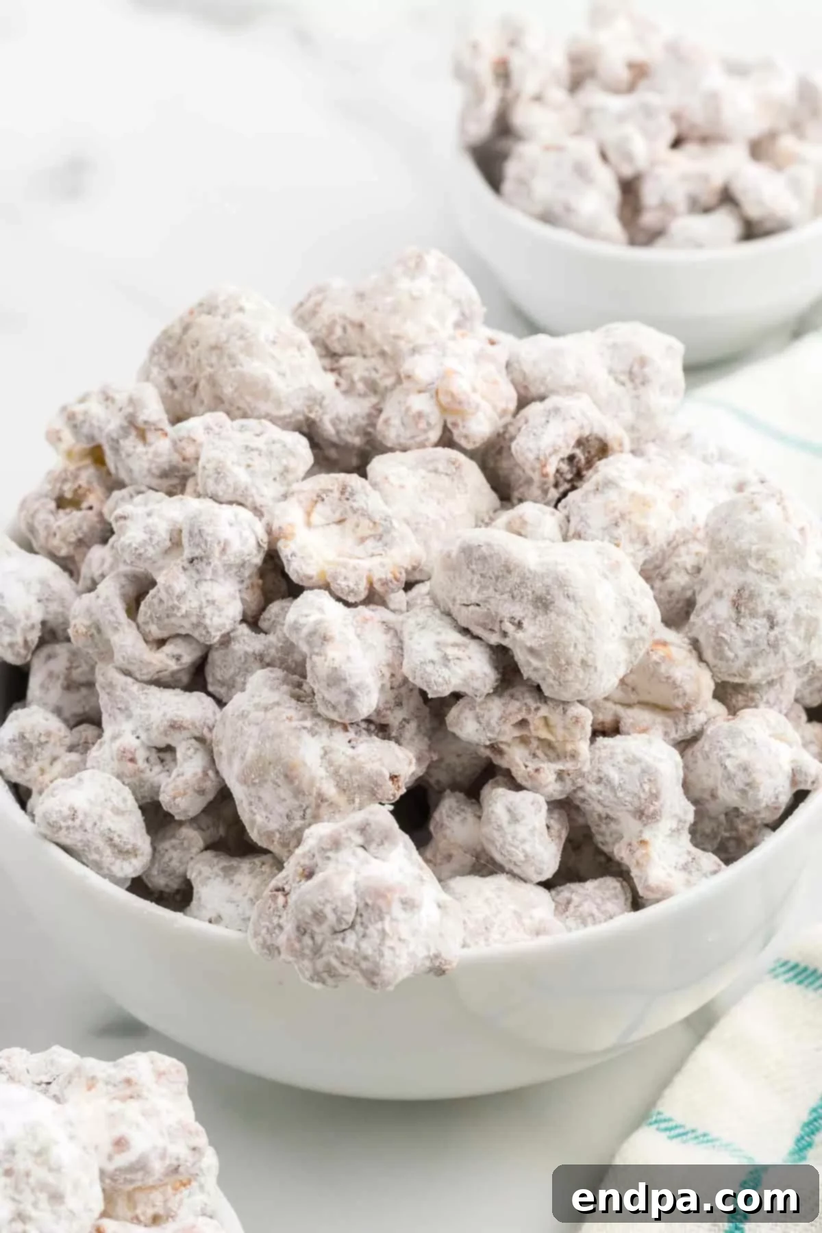 Muddy Buddy Popcorn Crunch 7 A bowl of finished Puppy Chow Popcorn, ready for serving.