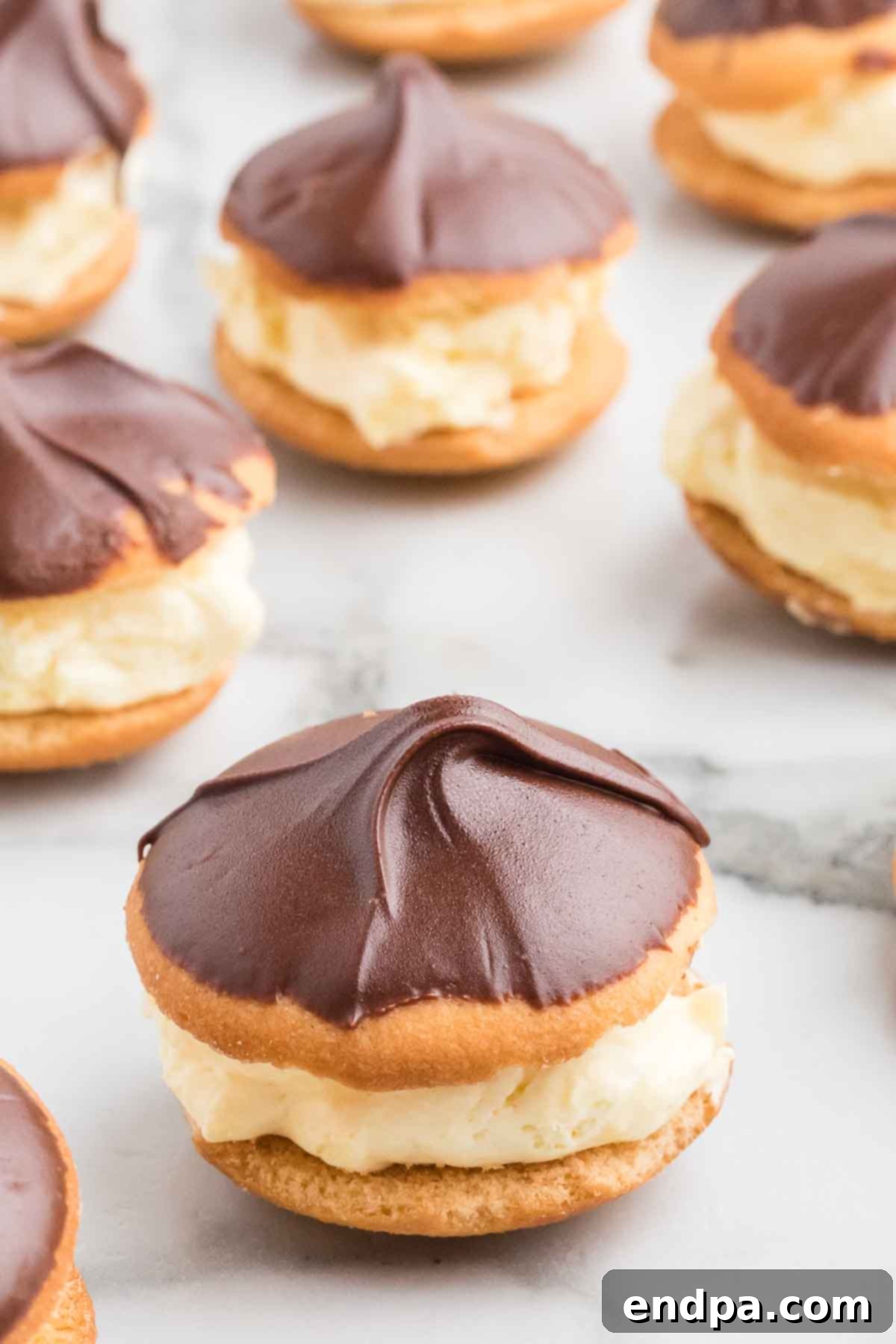 Eclair Cookie Fusion 2 Delicious Eclair Cookies beautifully arranged on a serving platter, showcasing the rich chocolate glaze and creamy vanilla filling.