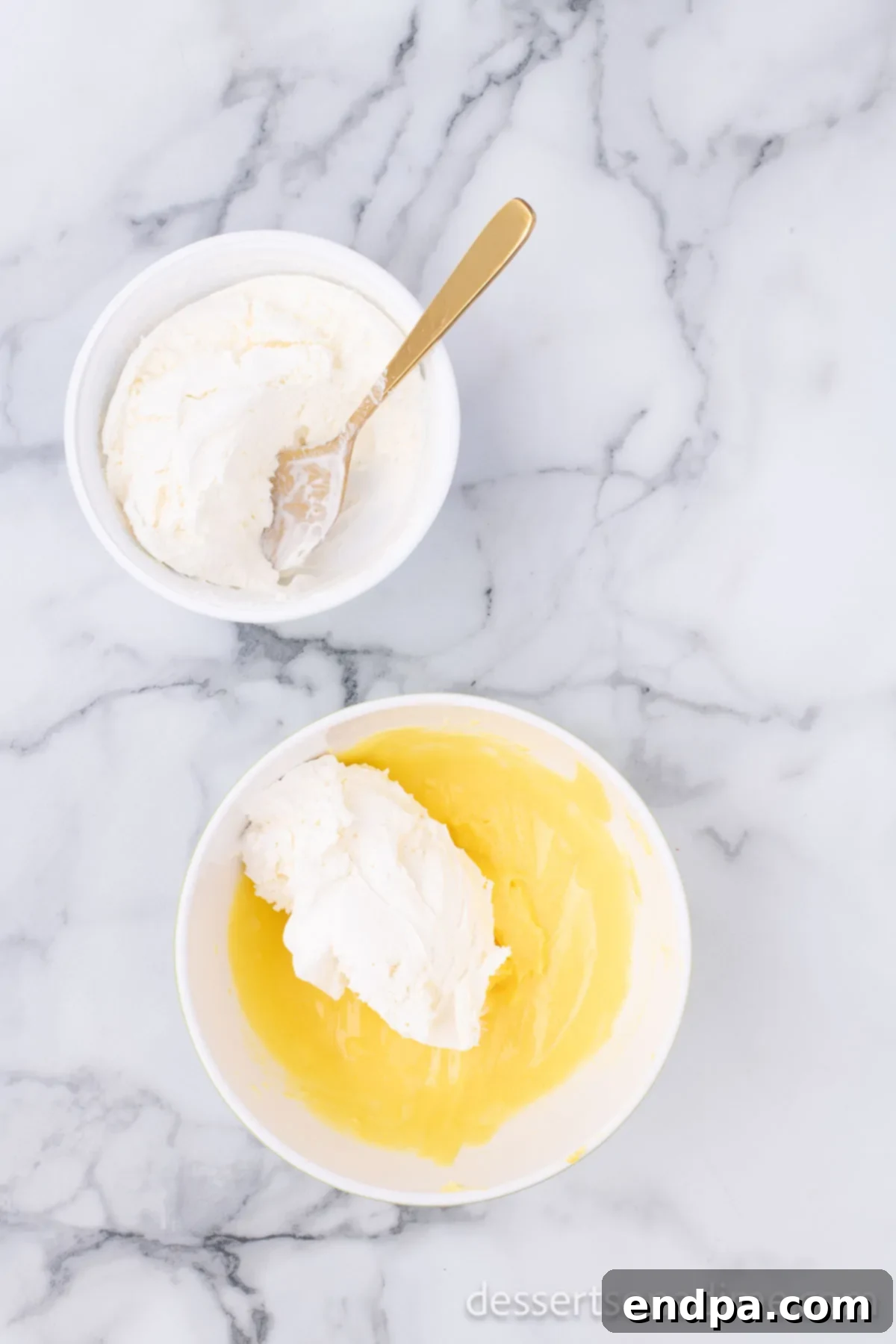Eclair Cookie Fusion 5 The smooth pudding mixture being gently folded into a dollop of Cool Whip in a large bowl, aiming for a light and airy eclair filling.