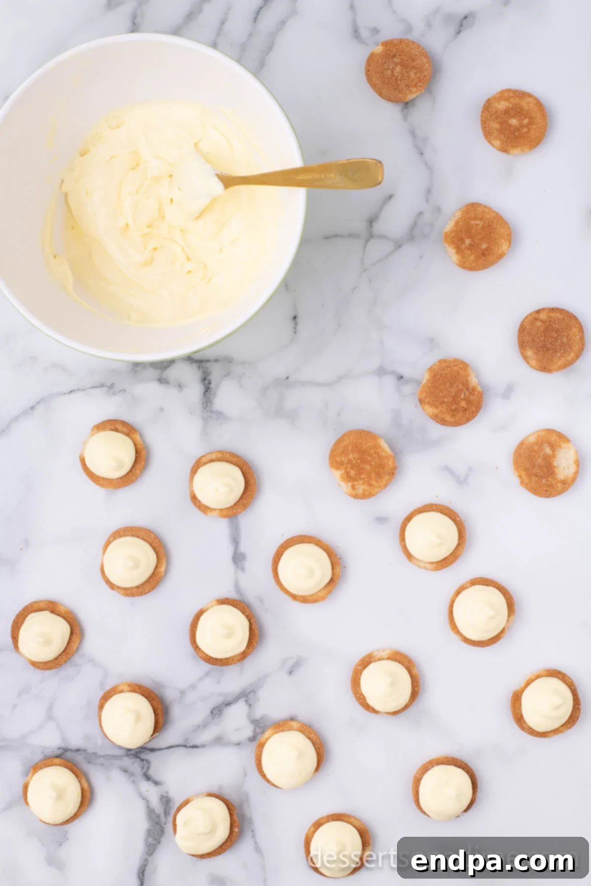 Eclair Cookie Fusion 7 A vanilla wafer cookie with approximately two teaspoons of the rich pudding mixture evenly spread on its flat side, forming the base of an eclair cookie.