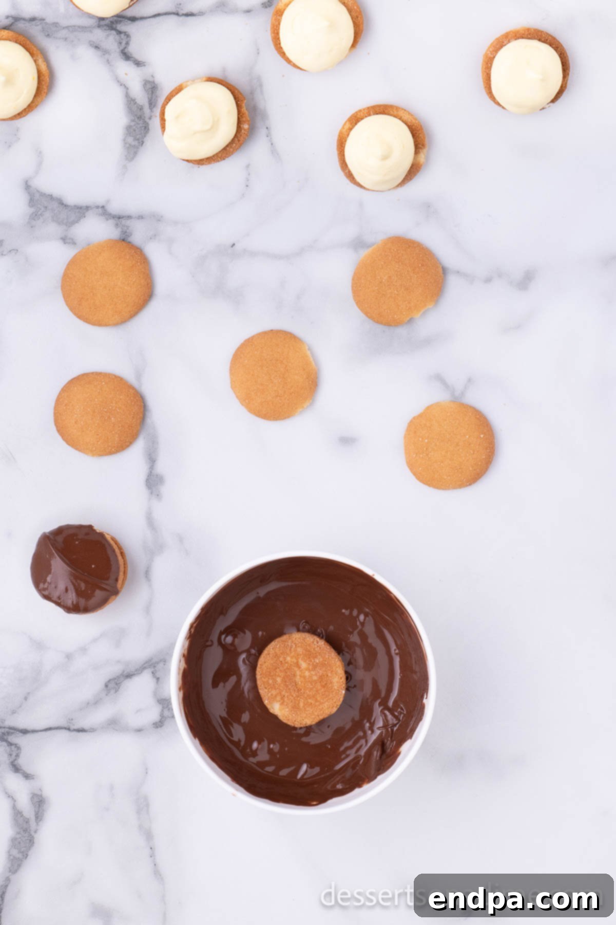 Eclair Cookie Fusion 8 A small, shallow bowl filled with perfectly melted semi-sweet chocolate, showcasing its smooth and glossy texture, ready for dipping.