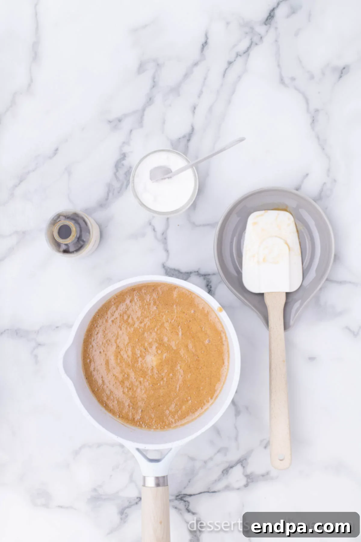 Homemade caramel bubbling in a saucepan, ready to coat the popcorn.