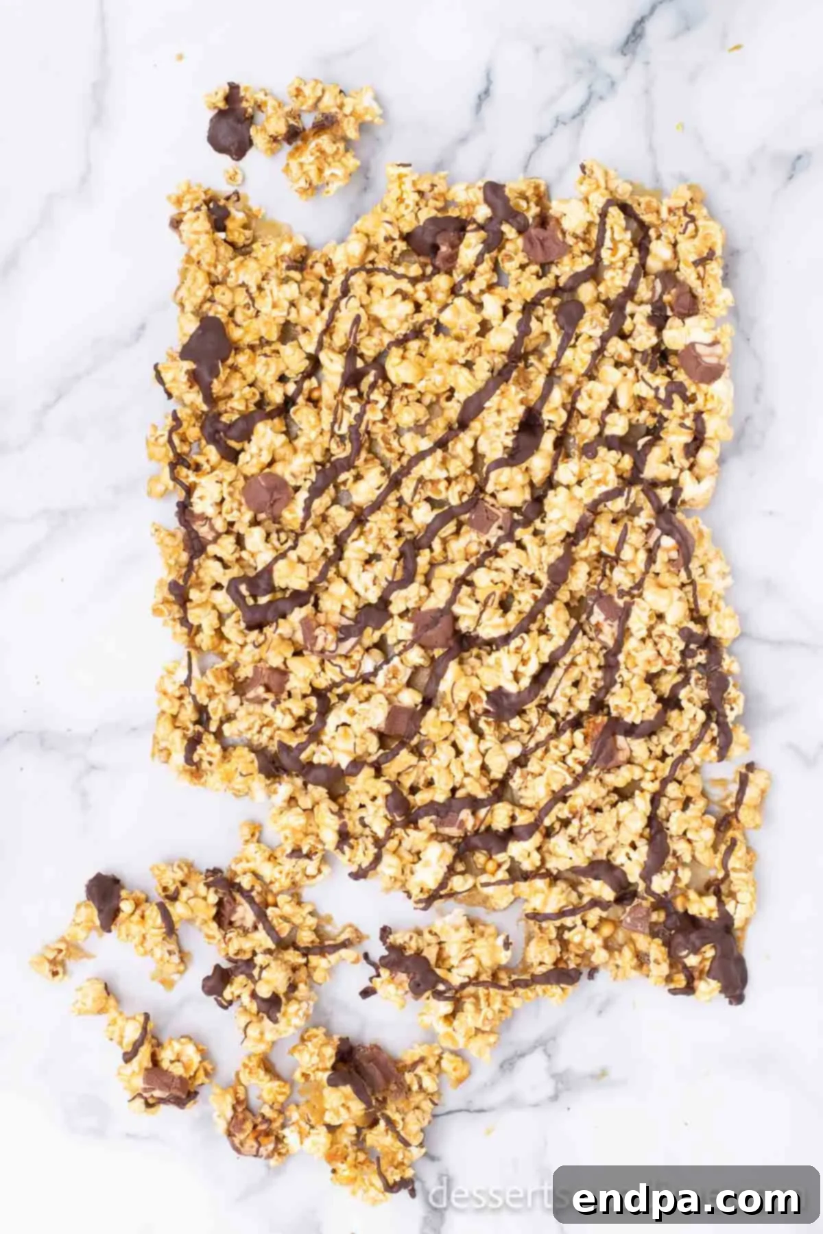 The finished Snickers popcorn, broken into delicious, bite-sized clusters, ready for enjoyment.