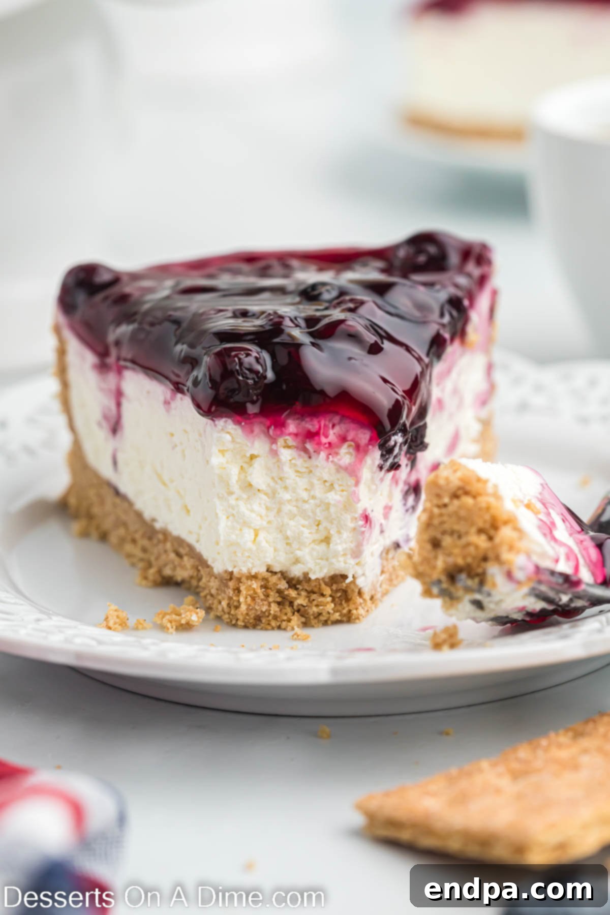 No bake blueberry cheesecake sliced on a plate. 