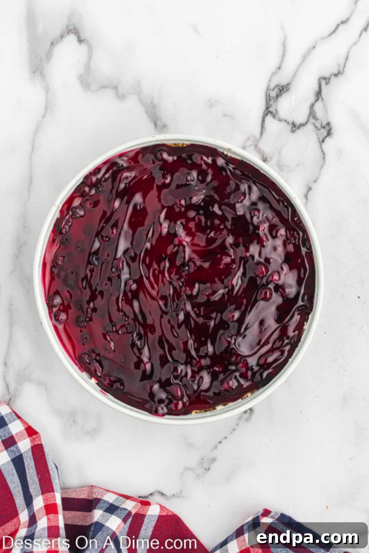 Blueberry pie filling spread on top of cheesecake. 