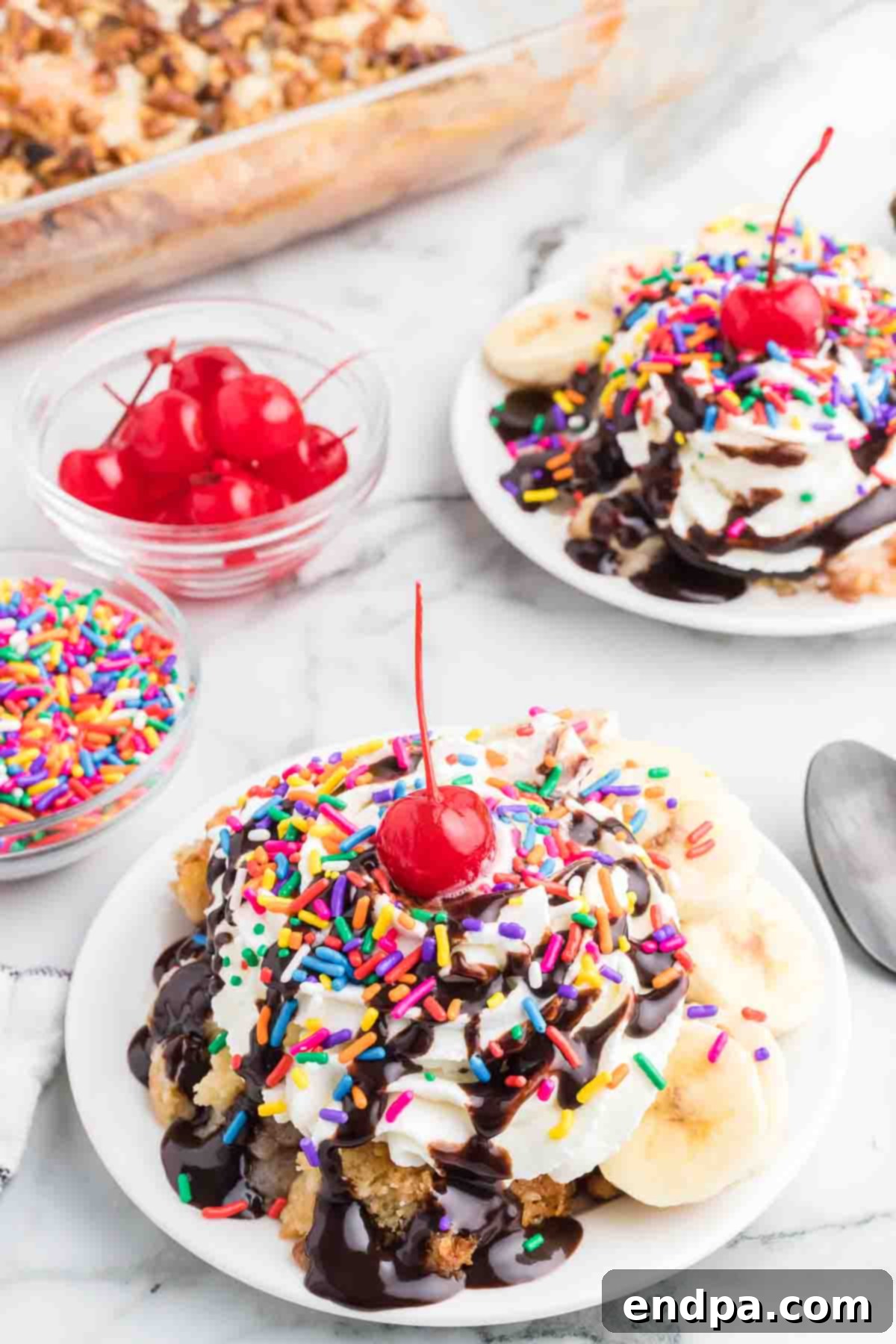 Oven-Baked Banana Split Treat 2 A beautifully presented banana split dump cake in a serving bowl, garnished with fresh toppings.