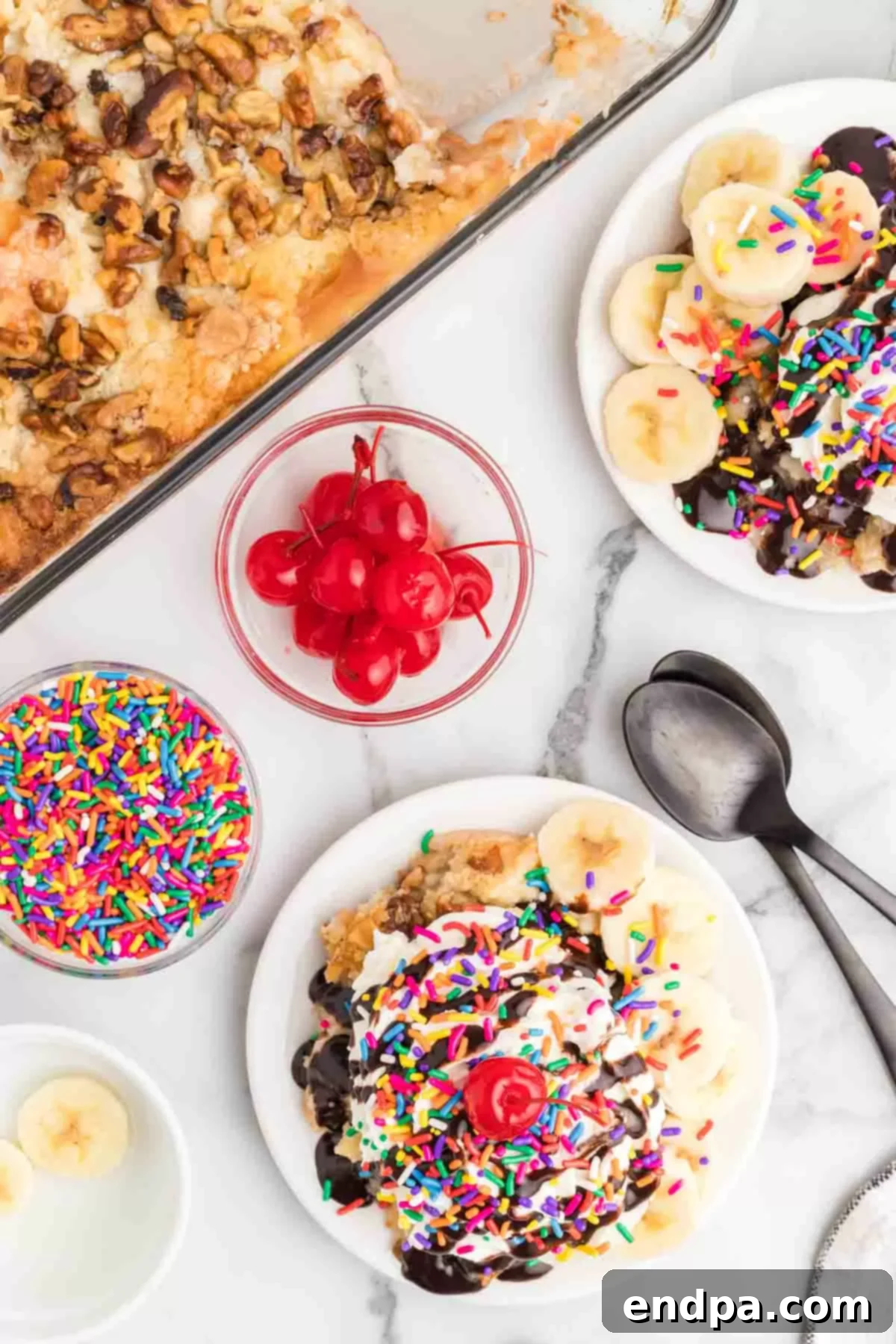 Oven-Baked Banana Split Treat 5 A serving of warm Banana Split Dump Cake topped with fresh bananas, chocolate syrup, whipped cream, a cherry, and sprinkles, ready to be enjoyed.