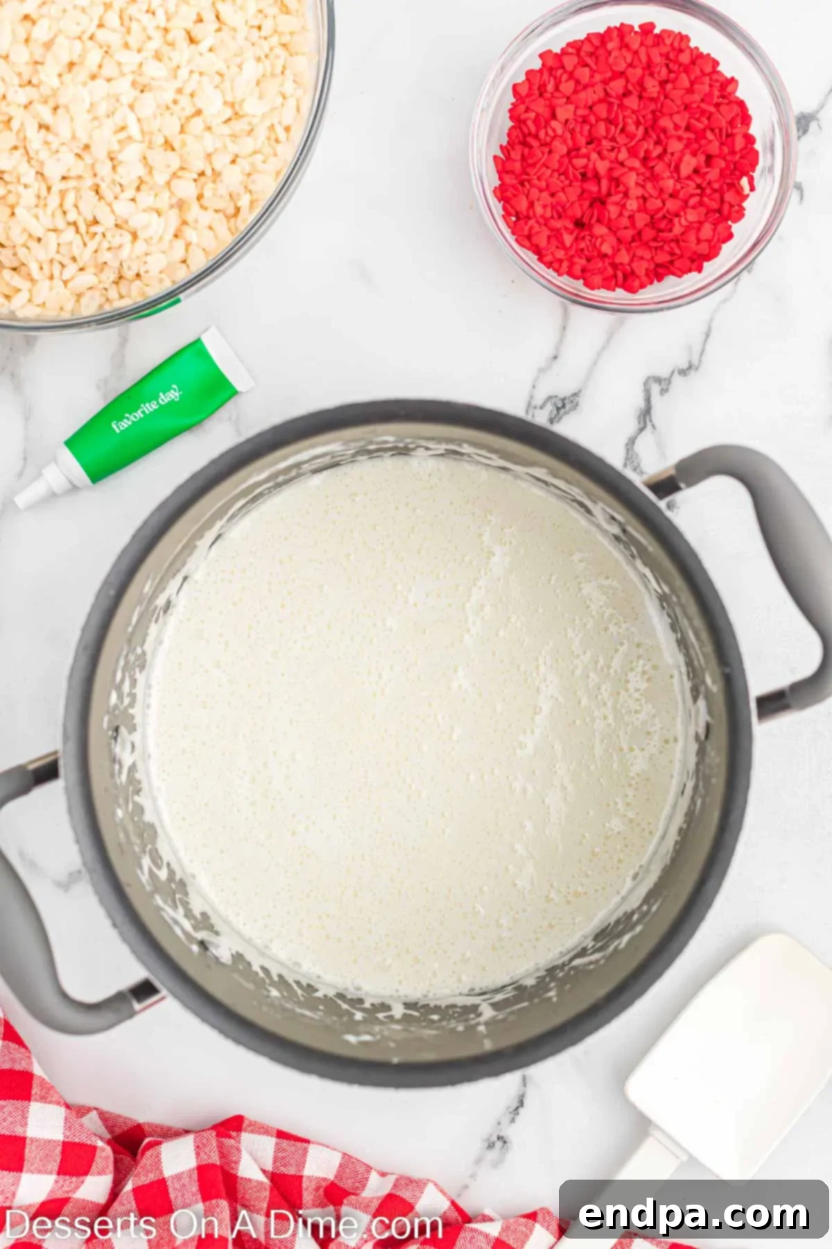 Sauce pan with melted butter and marshmallows, beginning to combine into a gooey mixture.