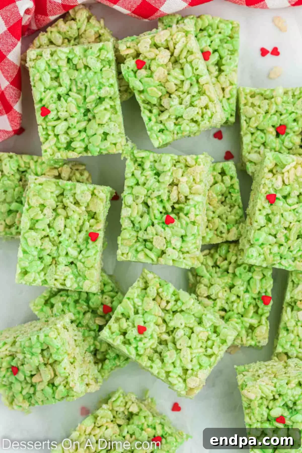Grinch Rice Krispie Treats perfectly cut into bars and arranged on a serving platter, ready to be enjoyed.