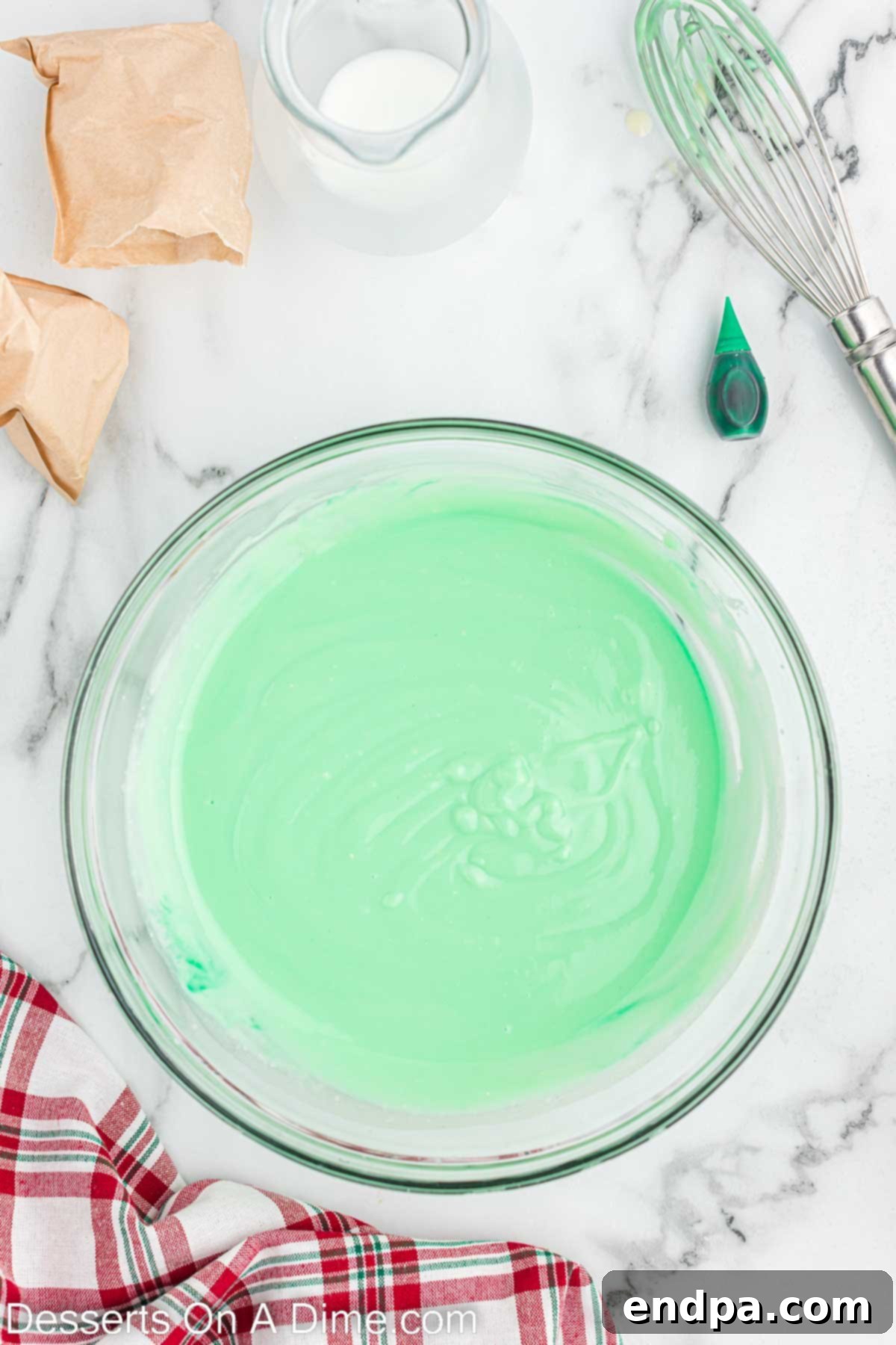 Green colored white chocolate pudding mixture in a bowl.