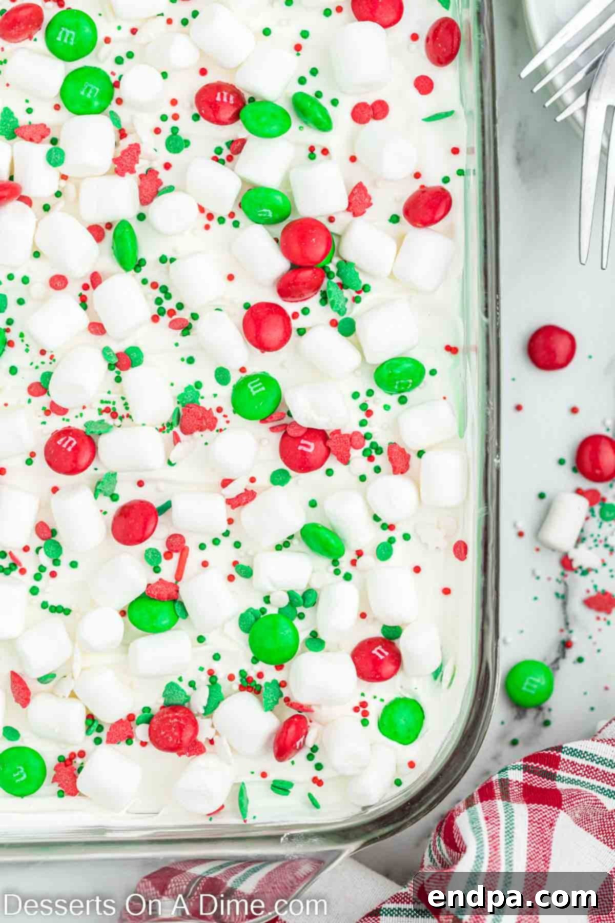 The finished Christmas dessert lasagna topped with mini marshmallows, sprinkles, and M&M's.