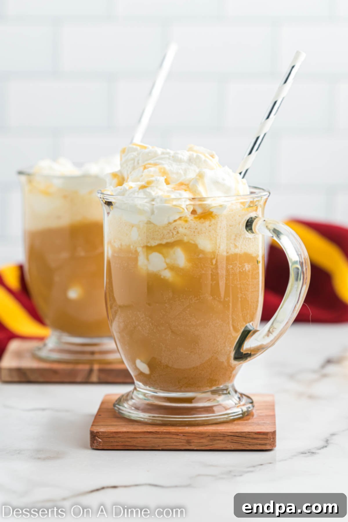 Hogwarts Signature Butterbrew 8 Butter Beer in a mug and topped with whipped topping, close up