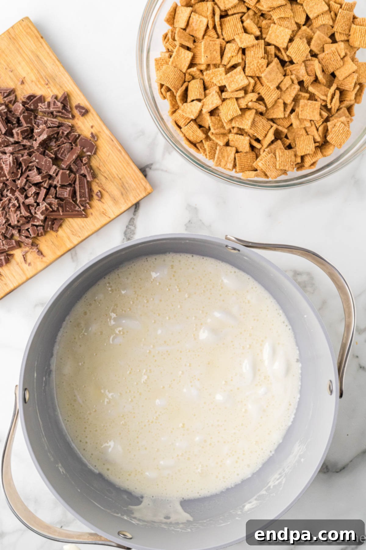 Large pot with melted butter and marshmallows, bubbling gently over low heat.