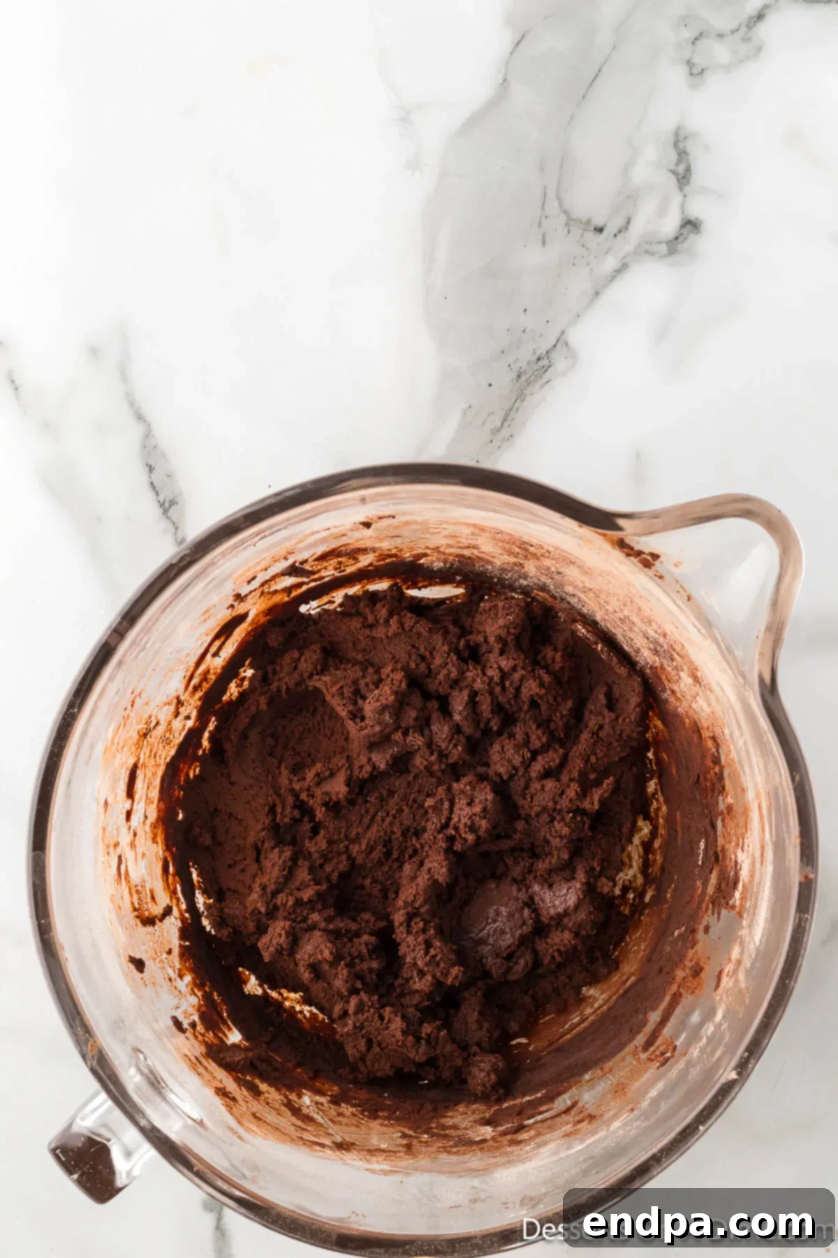 Crumbl Style Buckeye Brownie Cookies 13 Wet and dry ingredients combined together in a bowl.