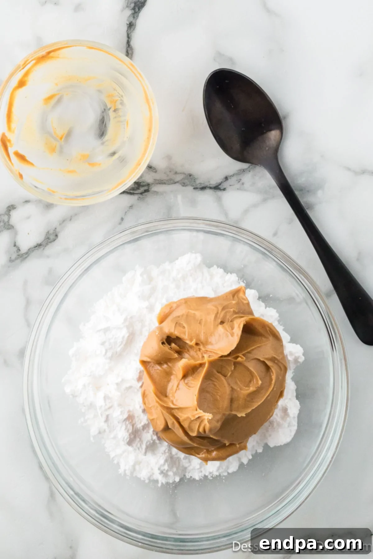 Crumbl Style Buckeye Brownie Cookies 16 Peanut butter and powdered sugar added to a bowl.