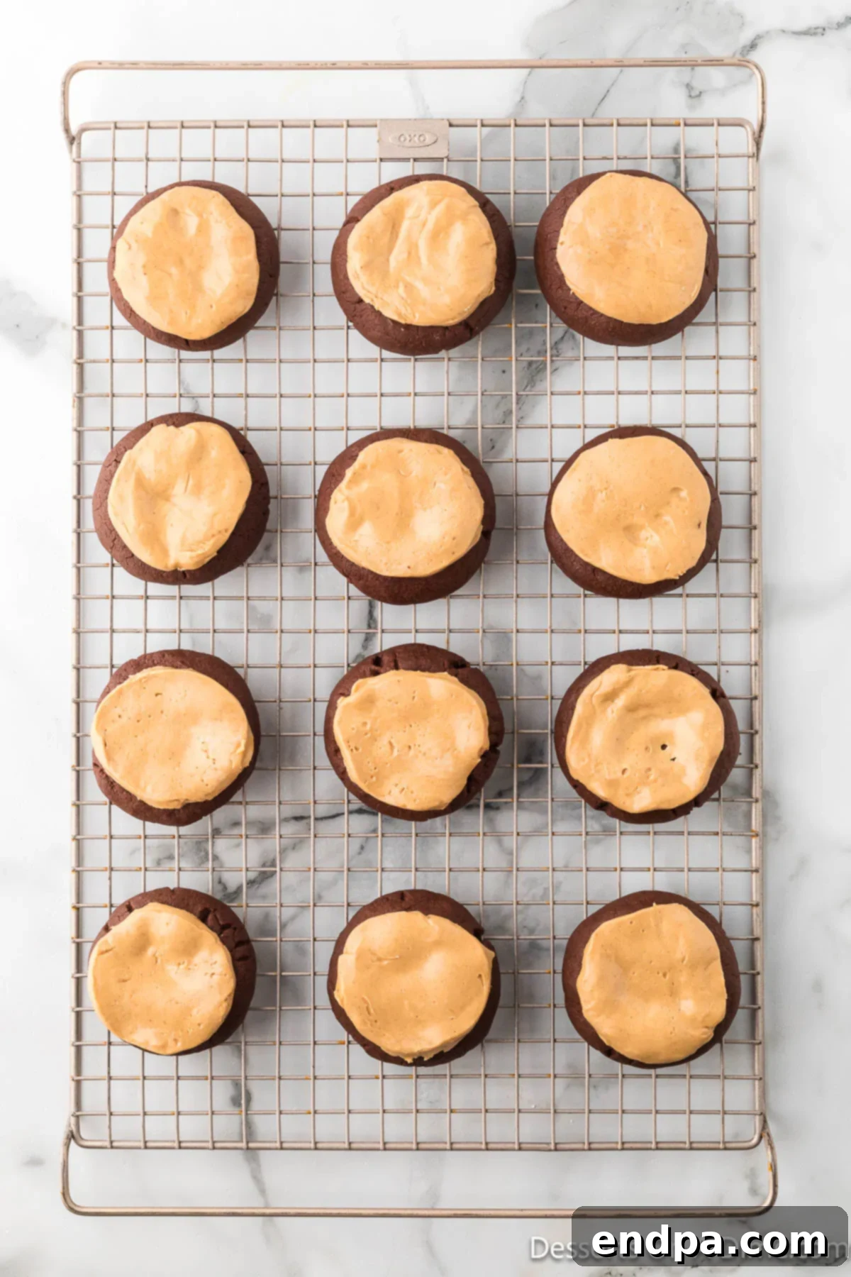Crumbl Style Buckeye Brownie Cookies 20 Peanut butter ball on top of each cookie.