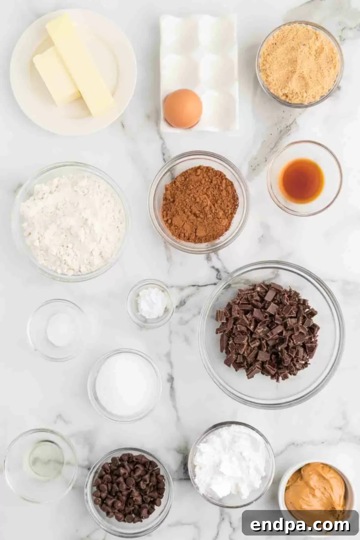 Crumbl Style Buckeye Brownie Cookies 3 Ingredients needed - flour, cocoa powder, chocolate chopped, butter, eggs, sugar, brown sugar, vanilla, baking powder, salt, powdered sugar, peanut butter, chocolate chips, coconut oil