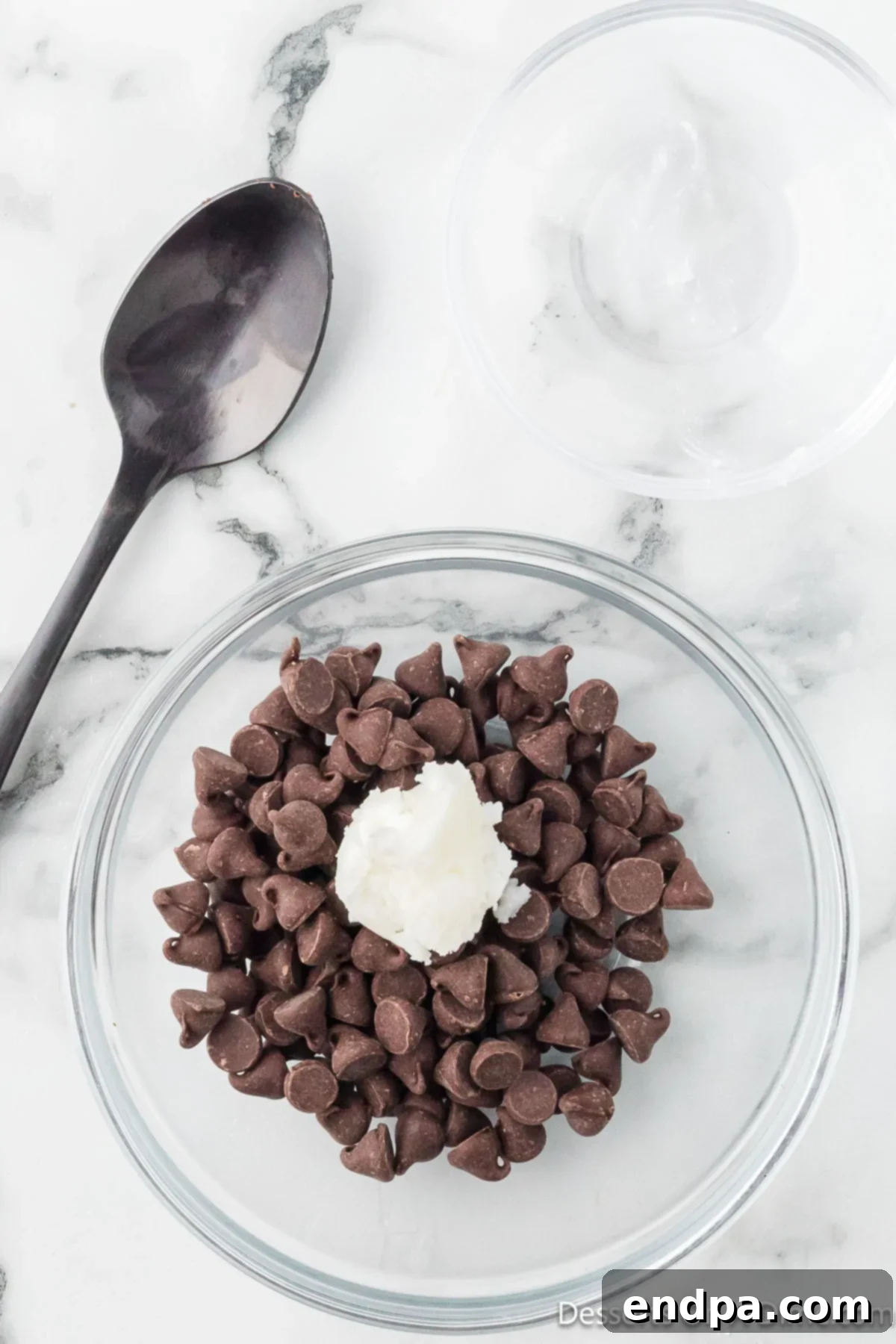 Crumbl Style Buckeye Brownie Cookies 21 Chocolate chips and oil in a bowl.