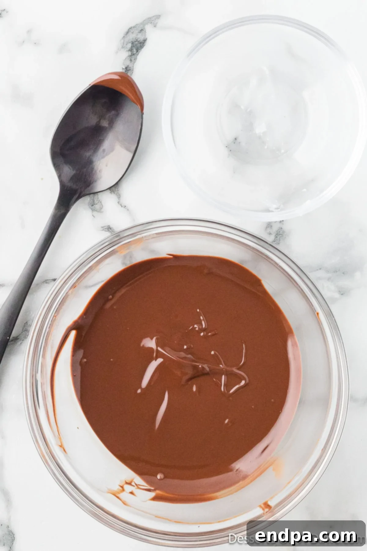 Crumbl Style Buckeye Brownie Cookies 22 Chocolate melted in a bowl.