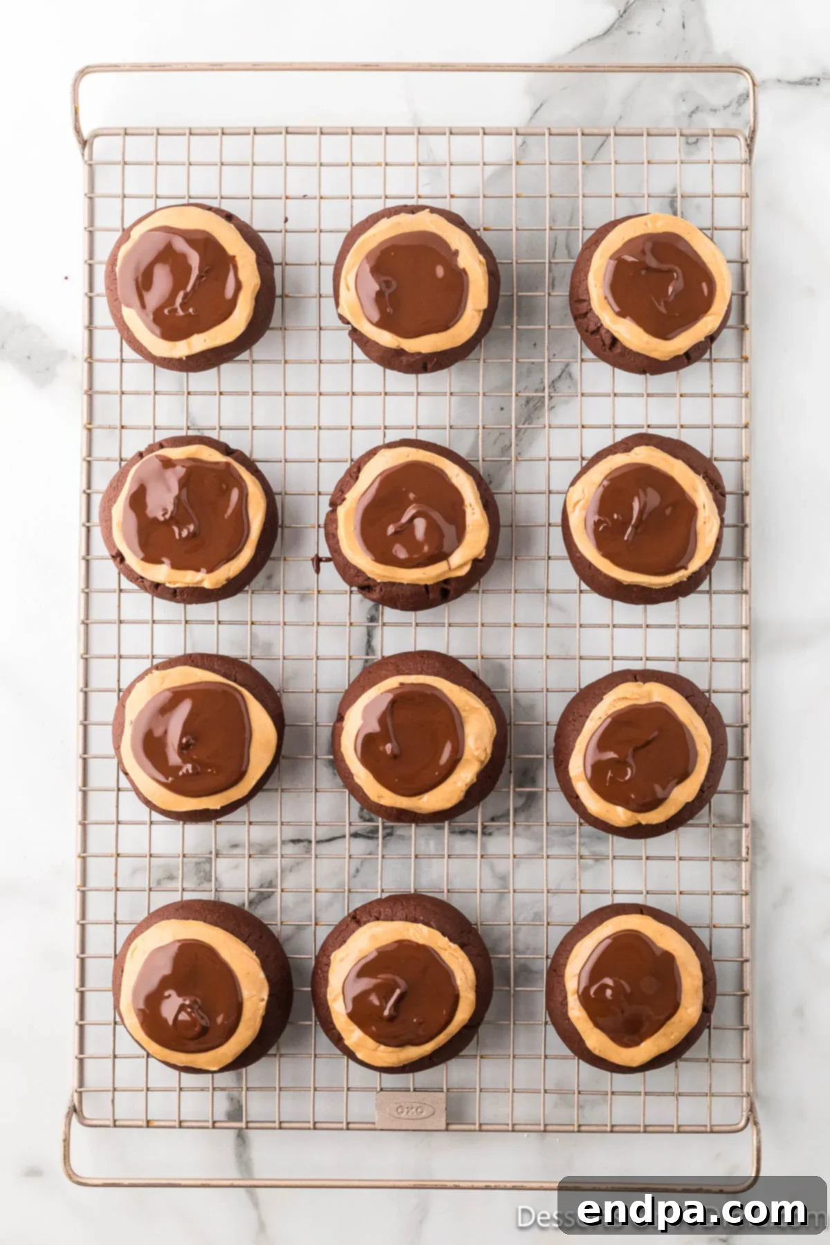 Crumbl Style Buckeye Brownie Cookies 23 Cookies on wire rack cooling.