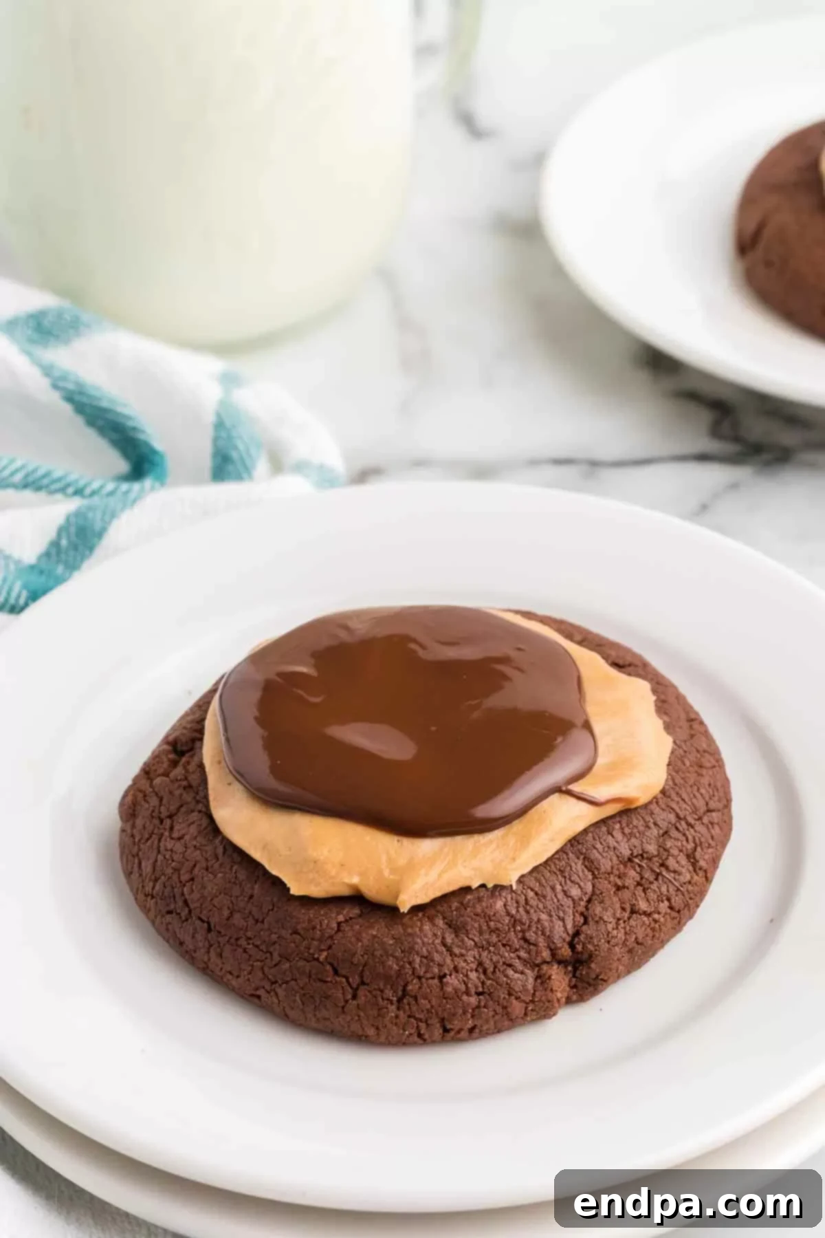 Crumbl Style Buckeye Brownie Cookies 24 Close up image of Buckeye Crumbl Brownie Cookies on a plate
