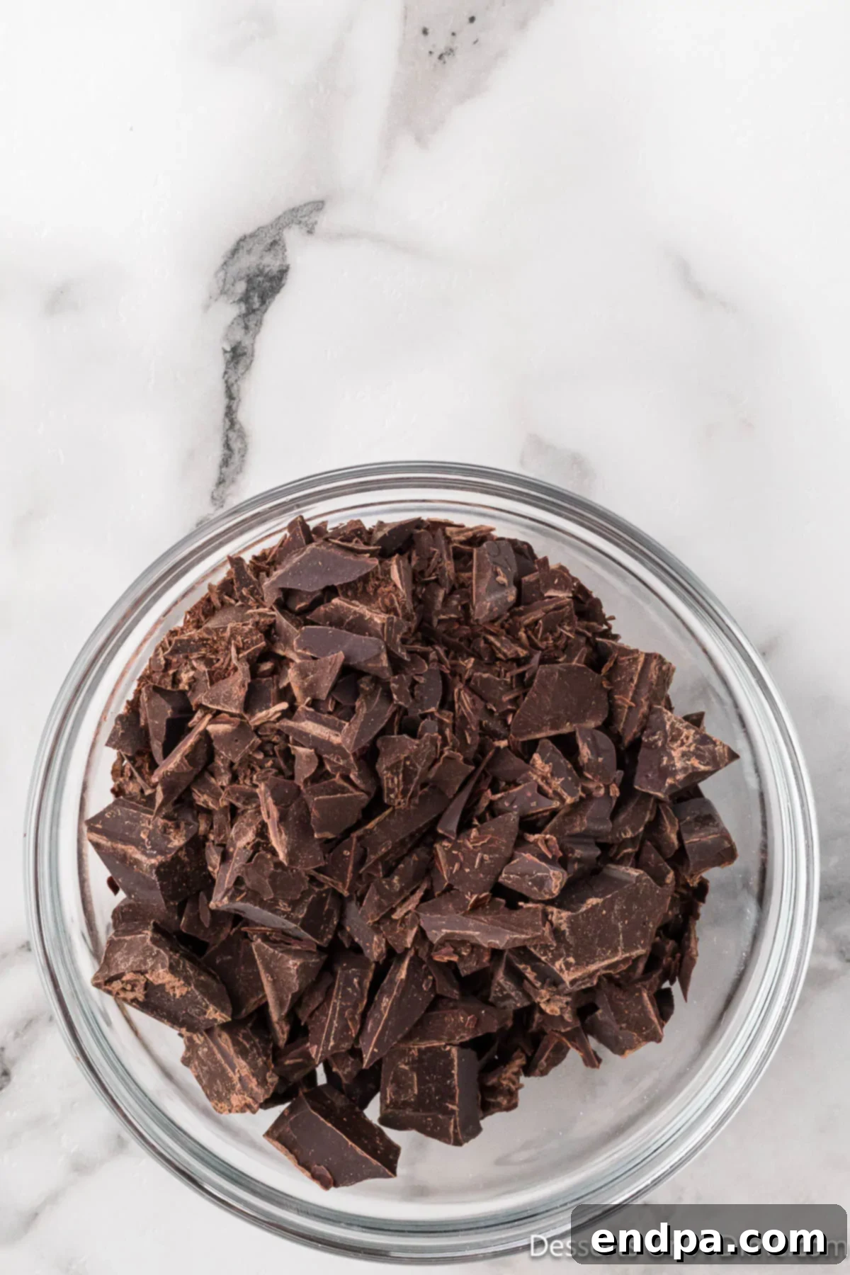 Crumbl Style Buckeye Brownie Cookies 4 Chocolate in bowl ready to melt in the microwave.