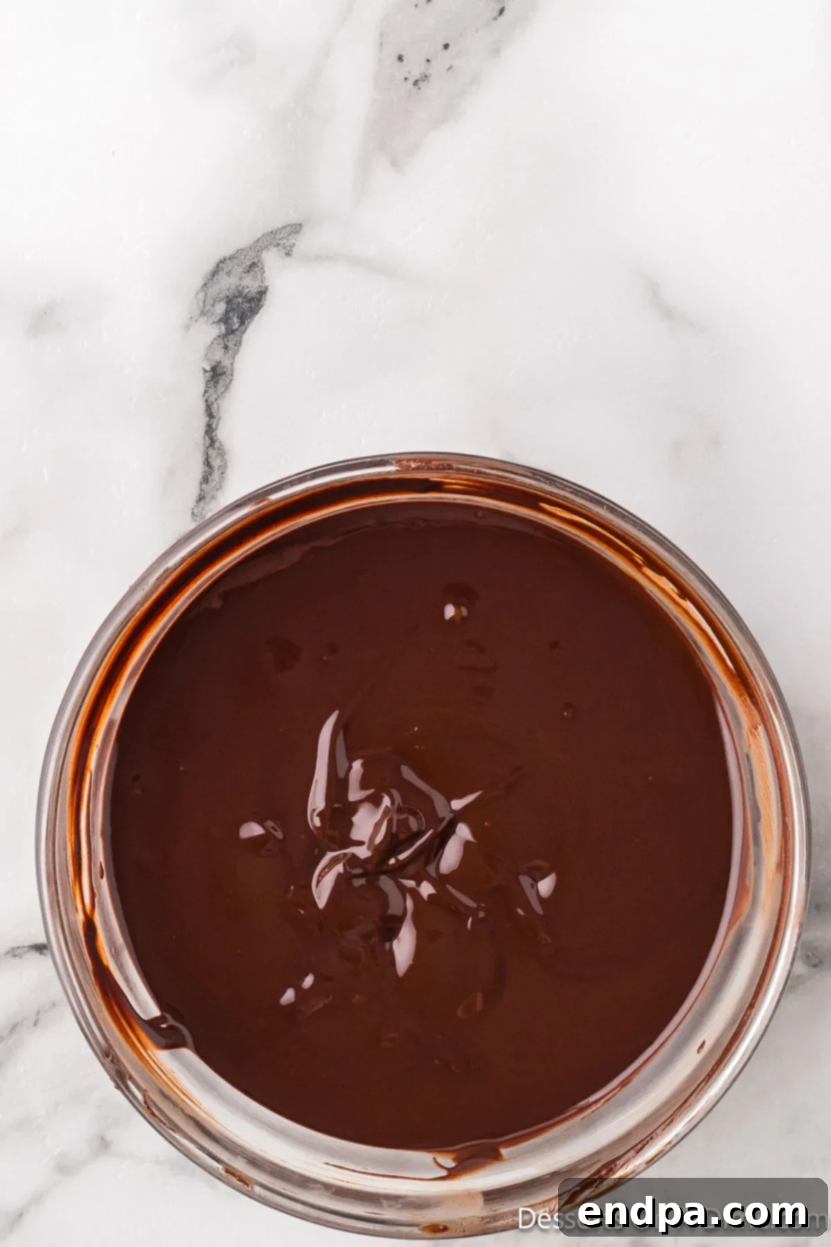 Crumbl Style Buckeye Brownie Cookies 5 Melted chocolate in a bowl.