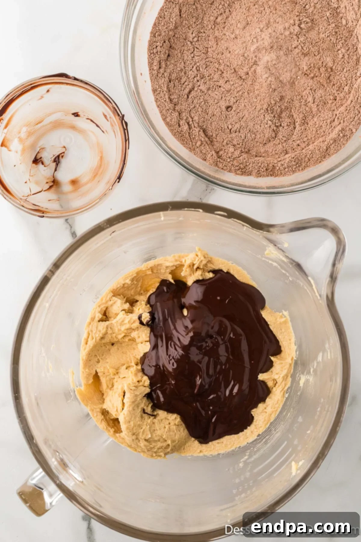 Crumbl Style Buckeye Brownie Cookies 10 Melted chocolate poured on peanut butter mixture.