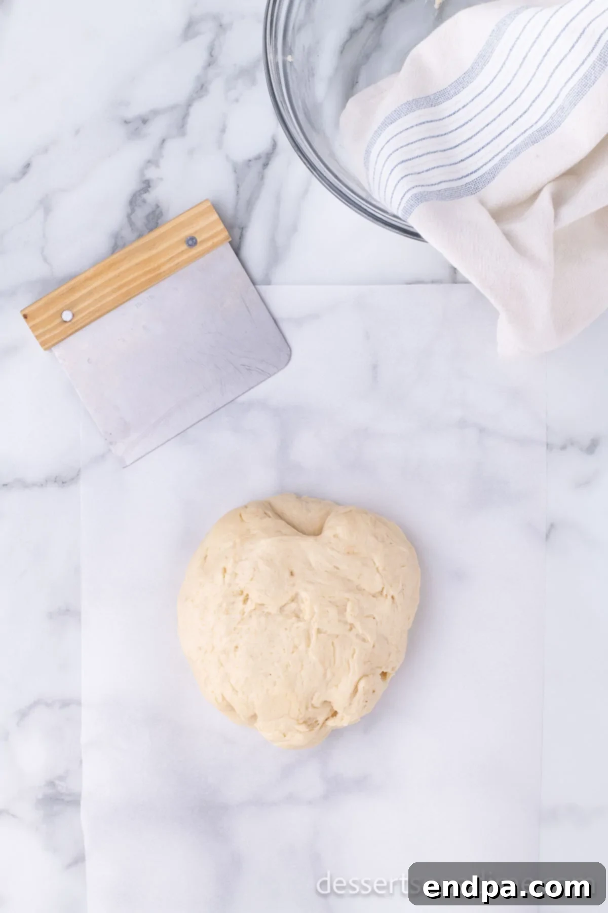 Krispy Kreme Donut Bites 13 Donut dough placed on wax paper, ready to be divided and shaped into individual donut holes.