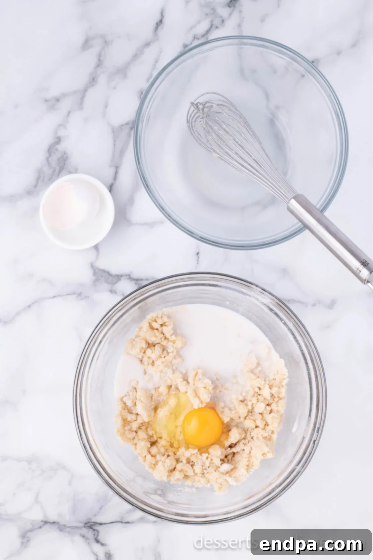 Krispy Kreme Donut Bites 9 An egg being blended into the donut dough within a mixing bowl, contributing to the dough's richness.