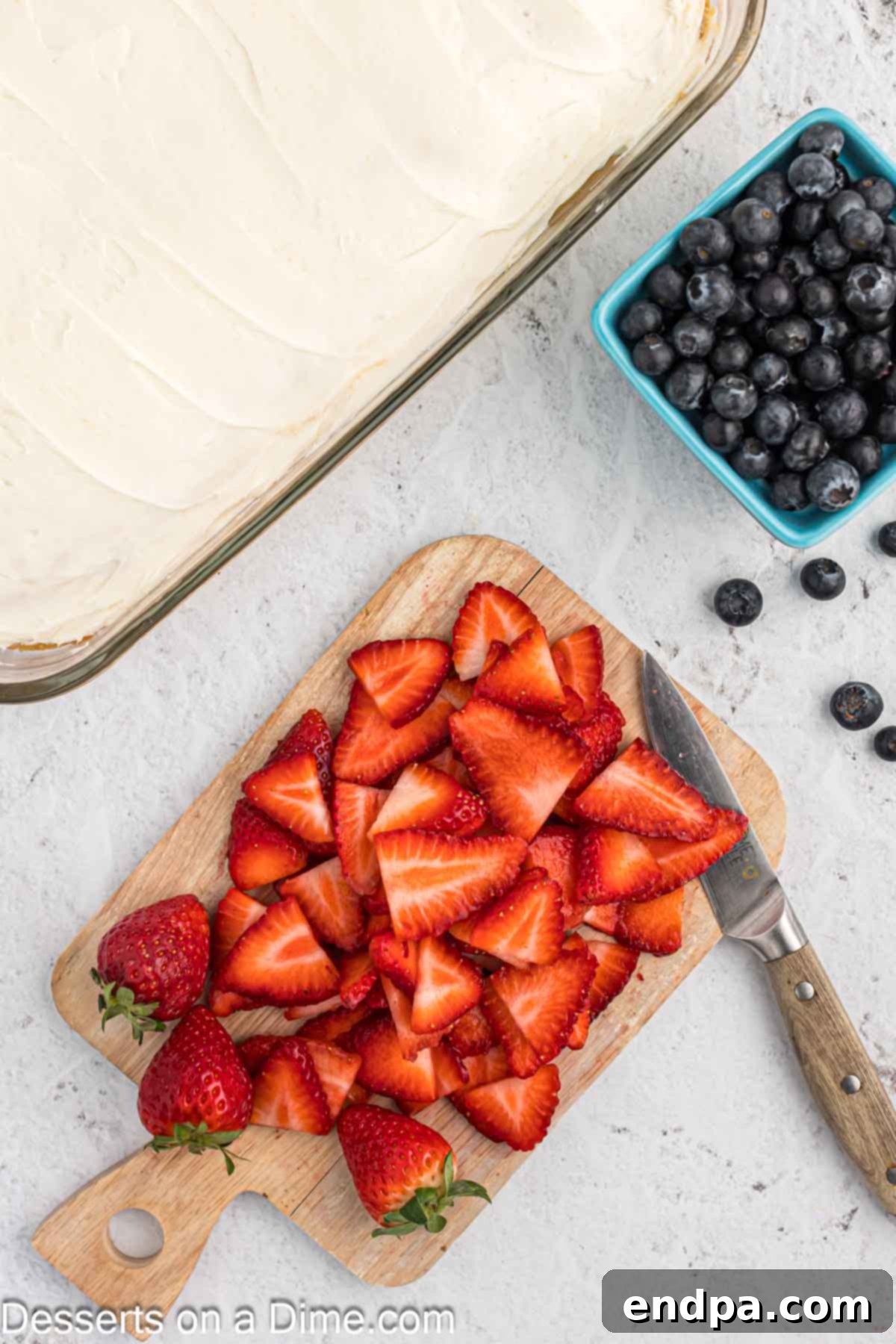 Fresh blueberries and strawberries, washed and prepped, ready for cake decoration.