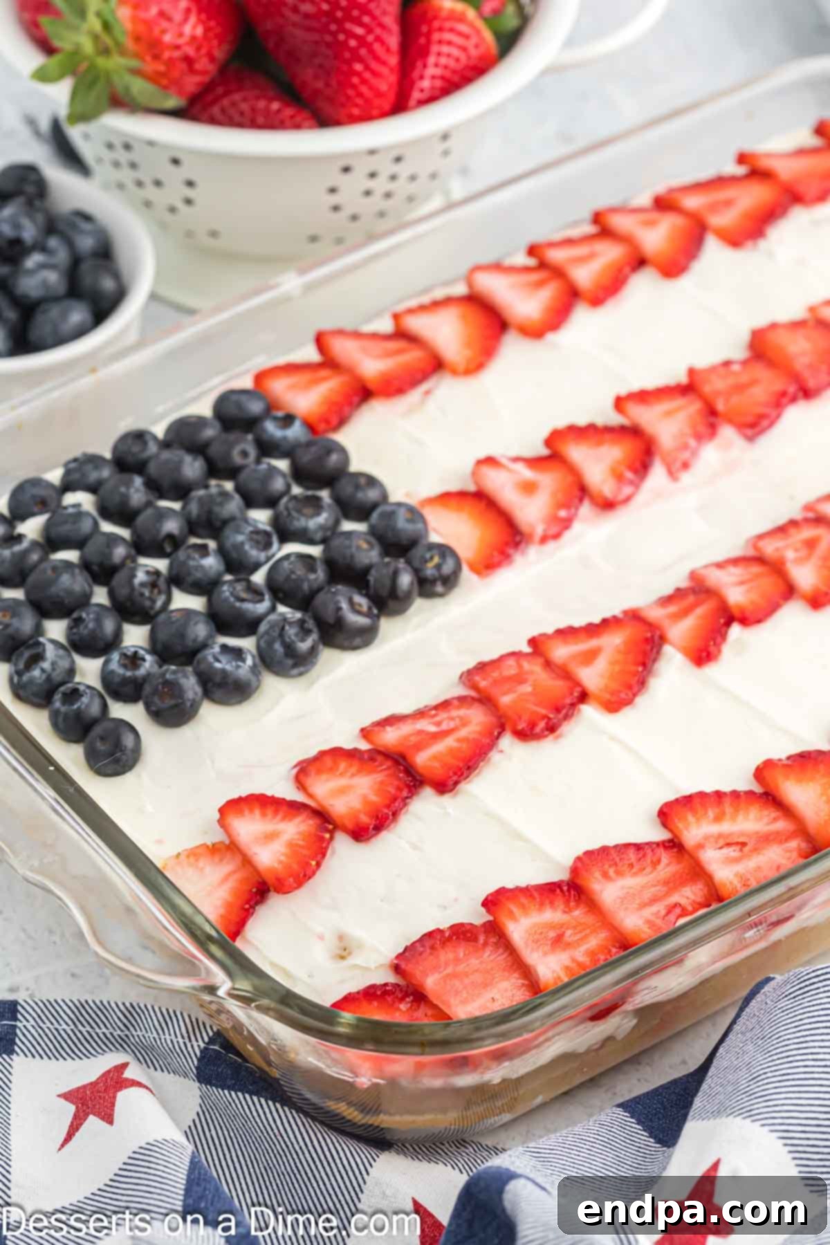 A close-up of a beautifully decorated American Flag Cake, ready to be served, showcasing the intricate berry arrangement.