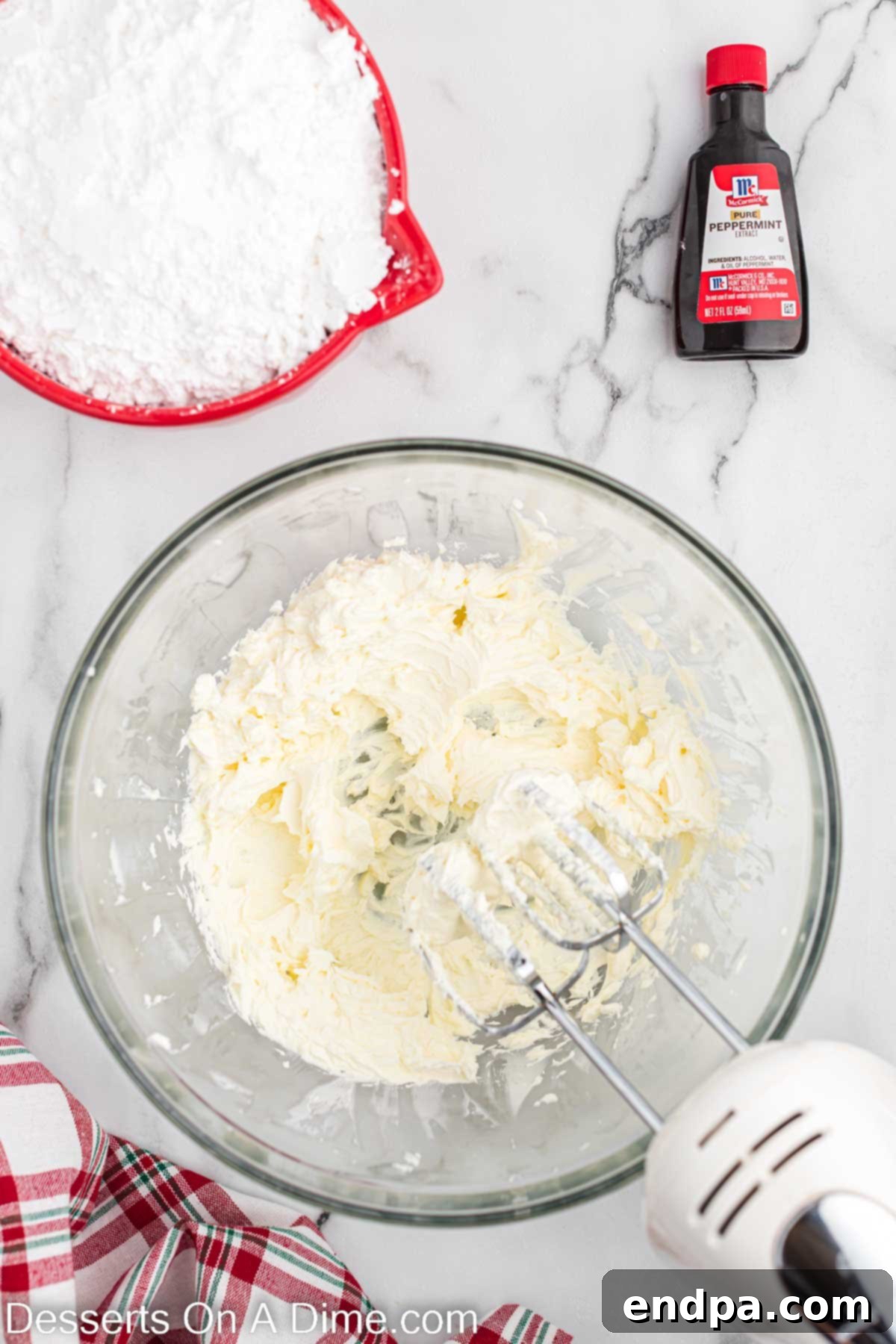 Softened cream cheese and butter are thoroughly combined in a mixing bowl.
