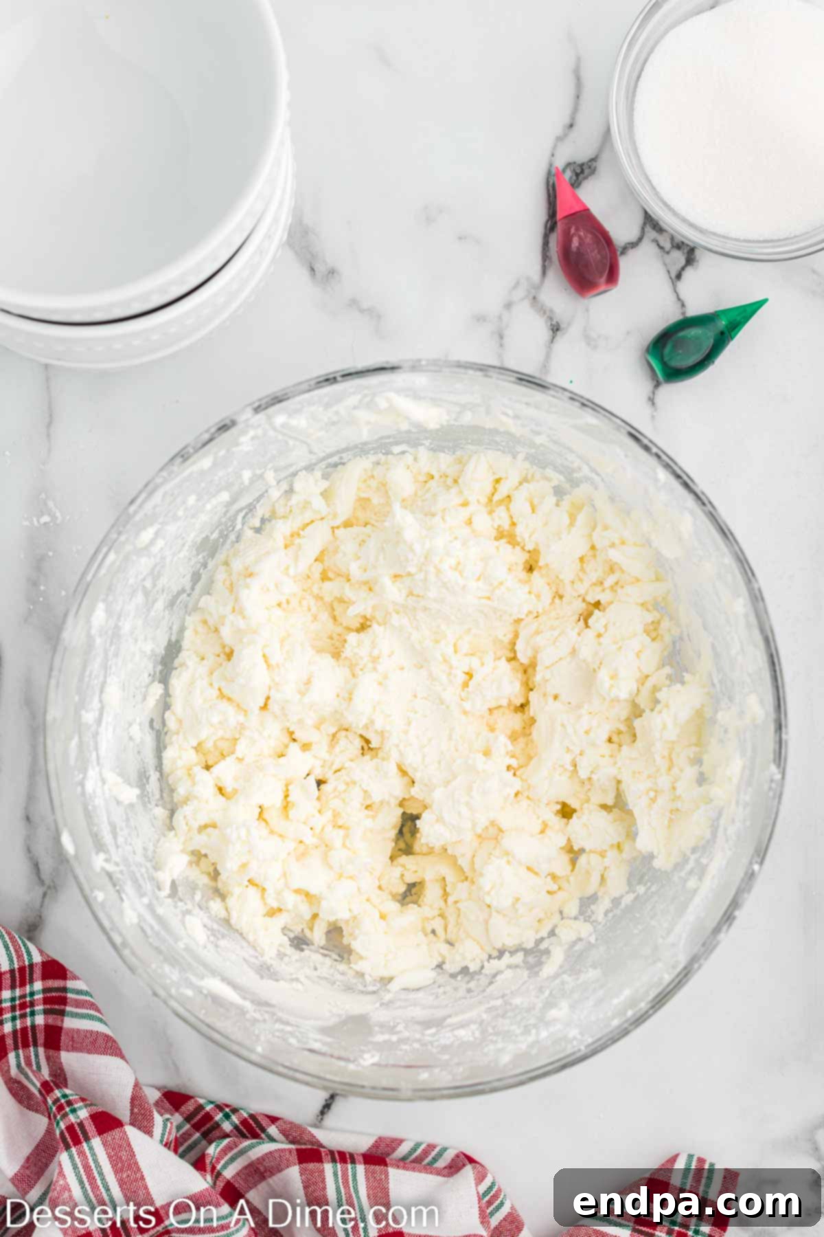 Powdered sugar is gradually added to the cream cheese and butter mixture and combined.