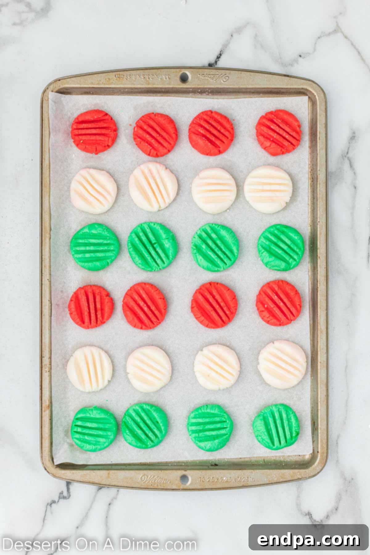 Finished mints are arranged on a baking sheet, ready to harden at room temperature.