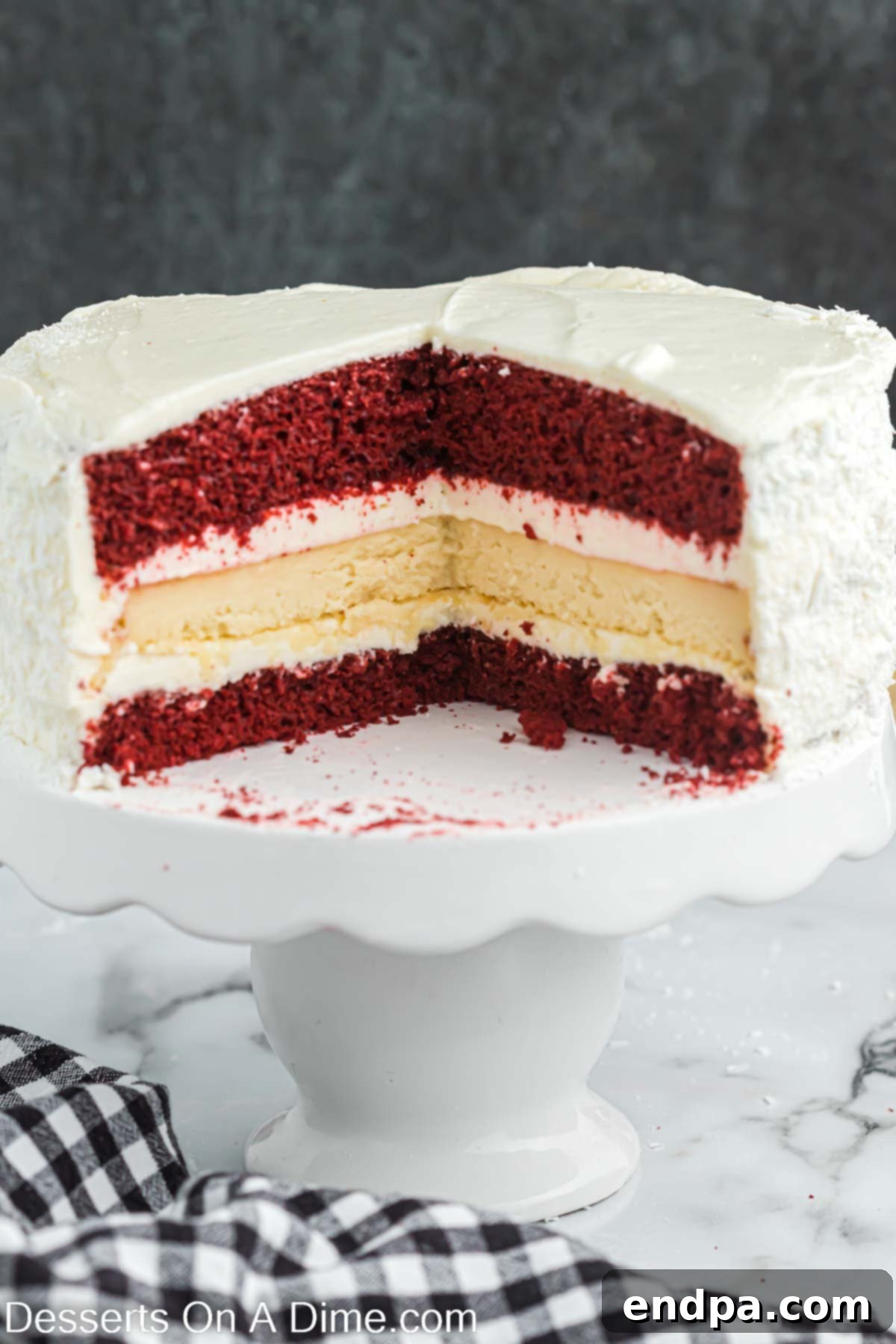 Stunning Red Velvet Cheesecake on a pristine cake stand, ready to be sliced and enjoyed.