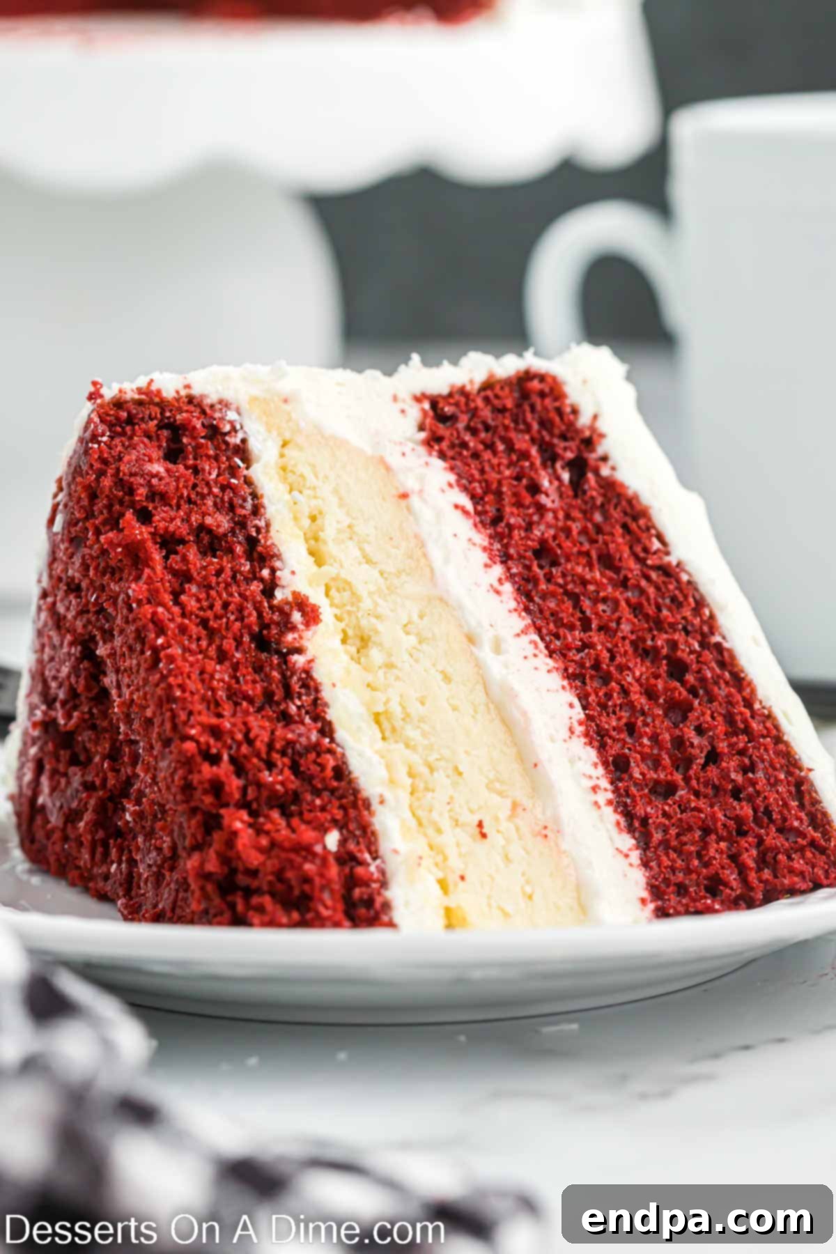 Another beautiful shot of a slice of Red Velvet Cheesecake, showing the rich layers and creamy frosting.
